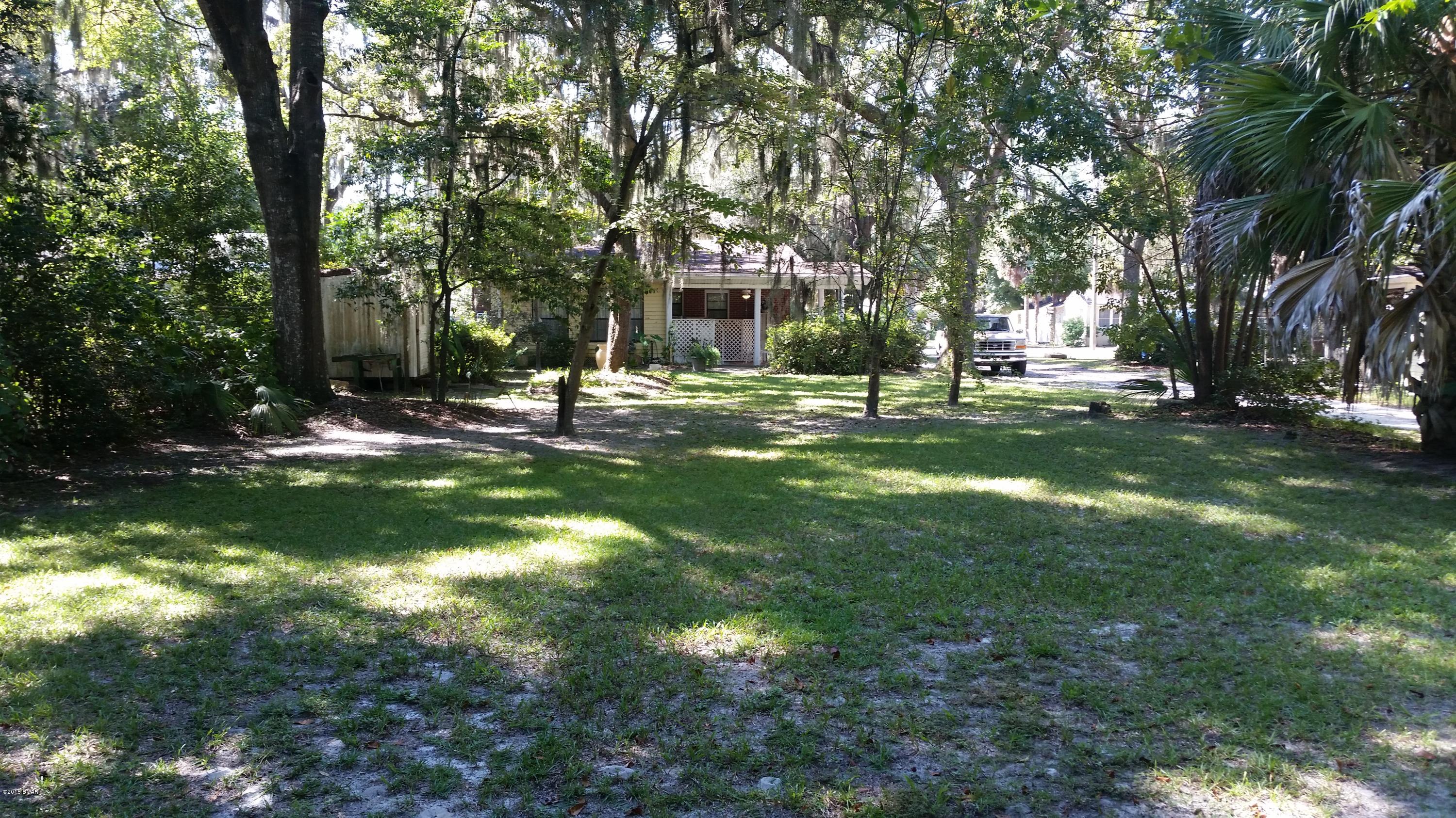 A unique older home in the Cove, the most exclusive neighborhood in the city. This home is on a very large lot, 217 feet deep and with alleys on two sides and on a city street.  The home has three bedrooms and 1 1/2 baths nice size family room with fireplace.  A screen front porch and a Carport on side of house. A great home for first time buyer or investor.