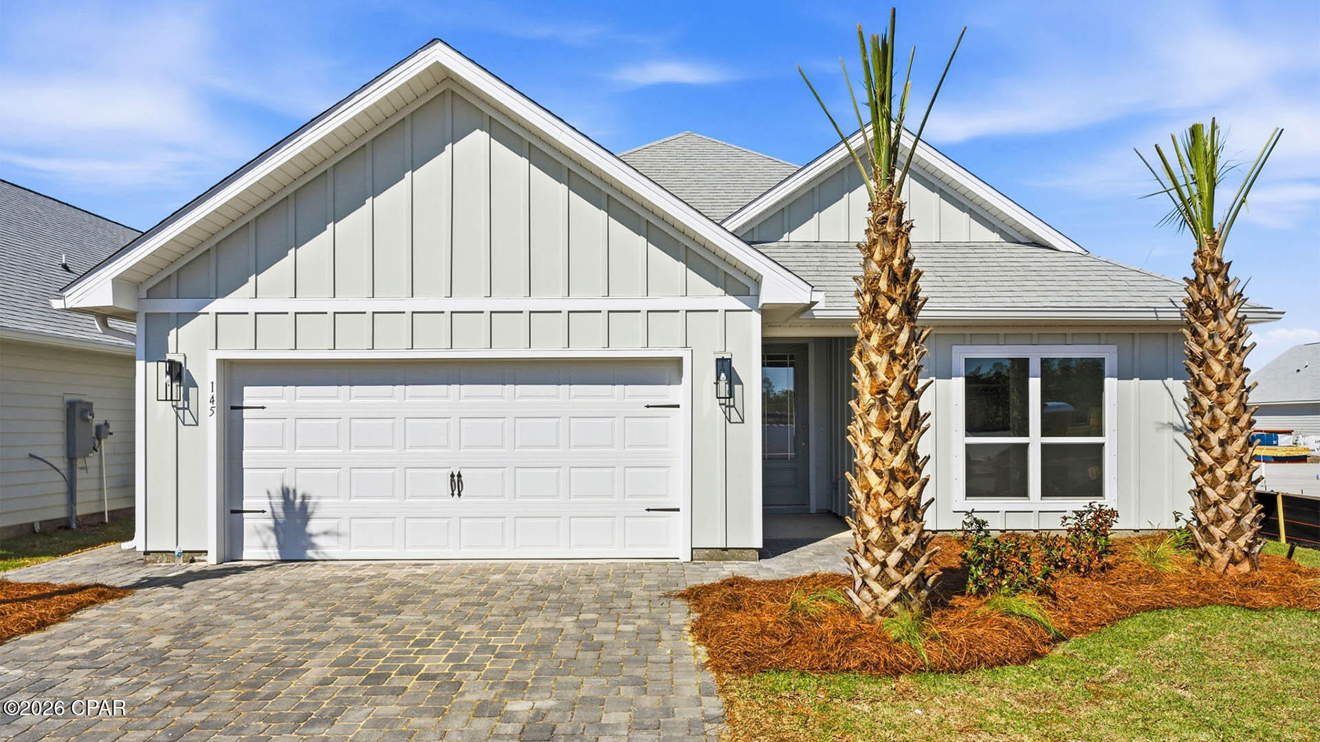 Welcome to 145 Greene Circle, a new home located at WindMark Beach in Port Saint Joe, Florida. As a part of our Emerald Series of homes, this beautiful single-story home boasts over 2,000 square feet of bright, open living and entertaining space as well as elegant, upgraded features. The Lily plan features four bedrooms, three full bathrooms, a spacious two-car garage, open floor plan design, and a large covered back patio.

As you enter the foyer, sleek EVP flooring leads the way to the living area and features two front bedrooms and a bathroom, with the fourth bedroom, third bathroom, and laundry room next to the garage entrance. The open concept living area is highlighted by the tall, vaulted ceilings and large windows, flooding this grand space with natural light and giving views to the covered back patio.

This gourmet style kitchen features a large kitchen island that sits looking into the family room and features a stainless-steel dishwasher, a farmhouse style sink, and beautiful, upgraded quartz countertops. The kitchen also features an electric stovetop range, a stainless-steel microwave and oven, a tile backsplash, and the walk-in corner pantry with built-in custom wood shelving.

On the other side of the kitchen, you will enter the secluded hallway to the primary suite which gives added privacy, elevated tray ceilings and three large windows. The elegant bath ensuite features an oversized tile shower with a glass door, separate soaking tub, dual sink vanity, stylish white cabinets with beautiful quartz countertops, and a large walk-in closet with custom wood shelving. Beyond the interior features and details, every home is equipped with Smart Home Technology. This thoughtful integration of technology ensures that your new home is perfectly designed to meet the demands of modern life.

On the outside of the home, there is quality Hardie® siding on all homes at WindMark Beach as well as outdoor showers. Exclusive to these Emerald series homes are concrete paver driveways, giving an even more upgraded look to your home. Enjoy quality materials and workmanship throughout, with superior attention to detail. Enjoy all the amenities the Windmark Beach community has to offer complete with beautiful new homes, local food, shopping, boardwalks, and beach access! Windmark Beach amenities includes two pools, BBQ grills, 11 dedicated beach accesses, the village center, boardwalk, and is pet friendly! The community is golf cart friendly, and dogs are allowed on the beach! We would love to give you a tour of our Lily plan today, connect with us today and see for yourself why WindMark Beach Emerald series homes are perfect for you!