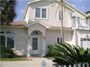 Very upscale home with open floor plan, custom kitchen cabinets, master bedroom downstairs, balcony with gulf view, fenced back yard, 1-car garage and walking distance to the beach!