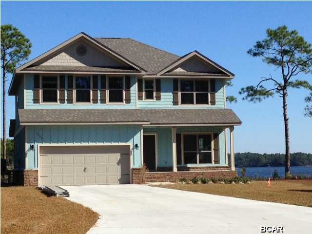 WATERFRONT (75') and you can build a BOAT DOCK on St. Andrews Bay! This highly desirable lot presents a unique opportunity as well an almost complete Julian floor plan. This spacious 2 story floor plan features the master with double closets on the 1st floor and a 5 ft. tiled shower is a beautiful addition to the master bath with double under mounted sinks and granite counter tops. The Julian also has 3 other bedrooms and 2 full baths plus a large Bonus room upstairs that is perfect for a media room or play room. And for parking you have a 2 car garage. All of this on a lot that allows for a boat dock and incredible views of the Bay from the screened porch. If you are a boat owner and desire beautiful coastal living near Tyndall AFB, THIS IS YOUR HOME!