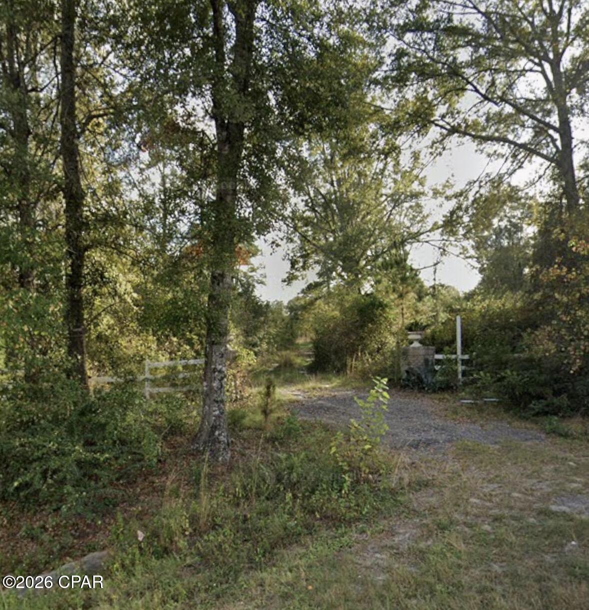 Spread across 38± acres just minutes from downtown Chipley, this property tells the story of a dream that's ready for its next chapter. Comprising two parcels with two separate access points directly off Hwy 90, it offers a rare combination of infrastructure, natural character, and room to grow.
The front half of the property is served by overhead power, while the back half was thoughtfully designed with underground utilities -- a detail that speaks to the intentional planning behind this land. Three wells are positioned across the property at the front, middle, and rear home sites, providing potential water access from end to end. Winding trails thread through the acreage, offering easy ways to explore, drive between parcels, and envision what this land could become. Highway 90 frontage is lined with existing fencing that, with a little care, could be restored to its prime.
Ponds dot the landscape -- once stocked with koi and a variety of fish, they were clearly well-loved and well-tended. Toward the back of the property, a previous home site anchors the rear parcel, complete with its own well (2010) and septic system (2015). The canvas is set for a new primary residence, guest home, or private retreat, pending buyer due diligence.
With Residential Low (RL) zoning allowing one dwelling per acre, the possibilities here are substantial -- whether your vision is a private family compound, an agritourism destination, or a thoughtfully developed residential community.
The previous owner saw something special in this land. Now it's your turn.
