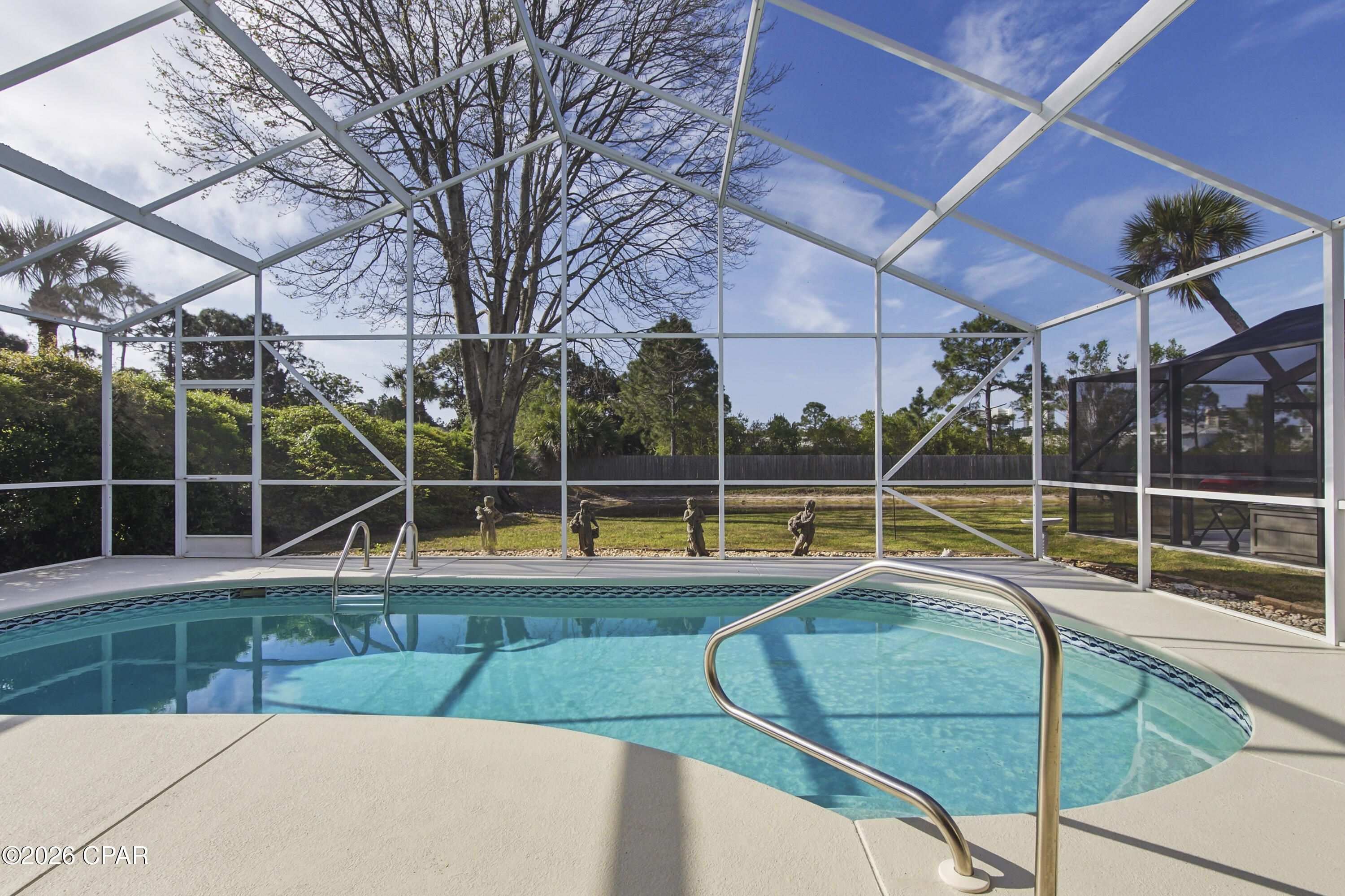 Welcome to your slice of paradise in The Glades! Ideally located just minutes from the white-sand beaches of Panama City Beach, this beautifully situated home offers the perfect blend of convenience and relaxation--only a short drive to popular attractions like Duplin Winery, shopping, dining, and entertainment.

Inside, you'll find a bright and inviting open-concept kitchen and living area, perfect for entertaining or everyday living. The seamless layout creates a spacious feel with plenty of natural light.

Step outside to your private retreat featuring a screened-in pool overlooking a peaceful pond, offering serene water views and added privacy. Whether you're enjoying your morning coffee or hosting guests, this outdoor space is designed for true Florida living.

Don't miss this opportunity to own a home in one of Panama City Beach's most desirable communities--close to the beach, yet tucked away in a quiet, scenic setting.