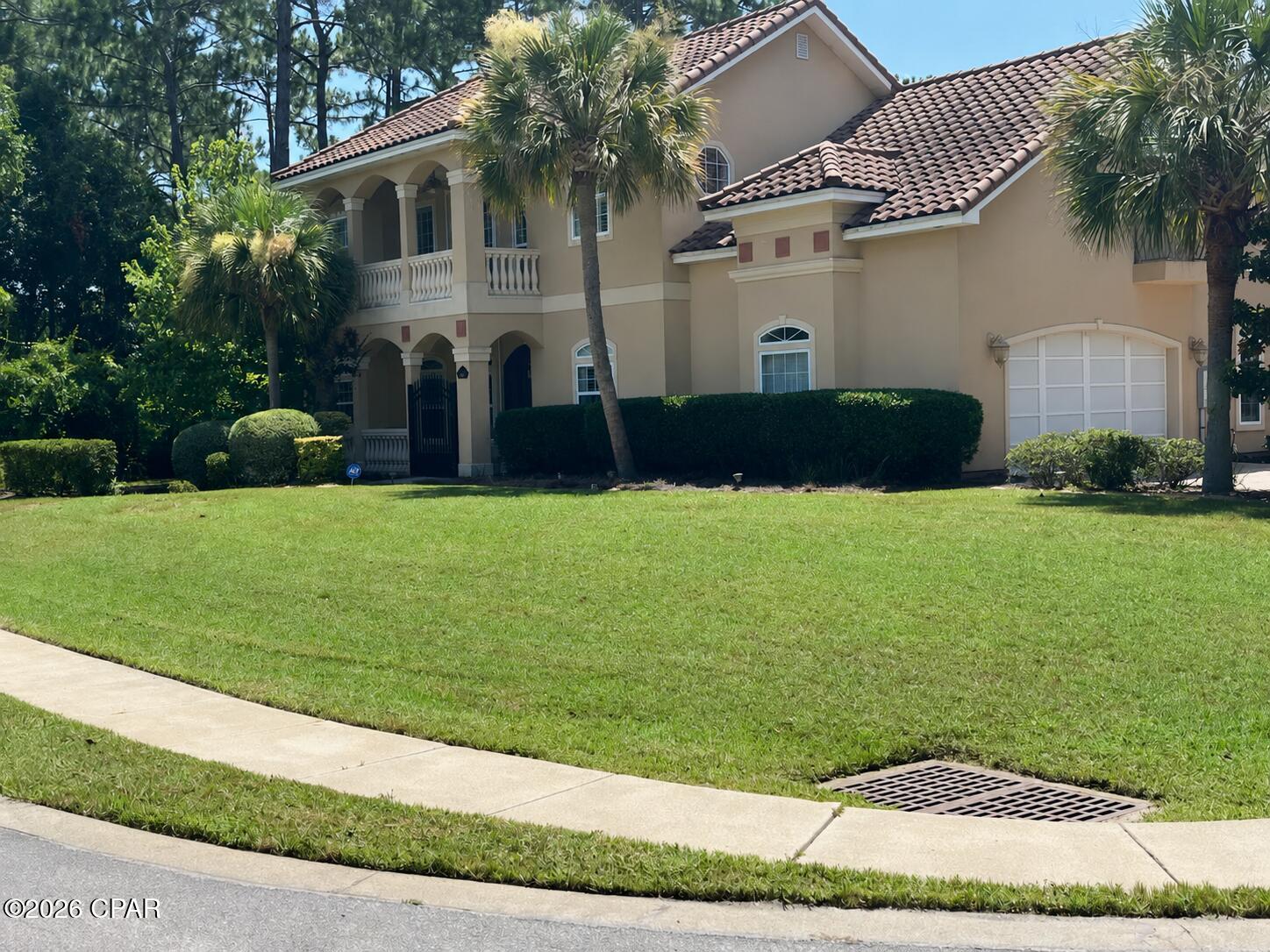 This  large Mediterranean-style residence presents a rare value-add opportunity in Trieste, one of Panama City Beach's most private and upscale gated communities, ideally located between Pier Park, the Gulf of Mexico, and St. Andrews Bay.
Offering  3,265 heated and cooled square feet and 4,248 square feet under roof, the home features four or five bedrooms with . The previous owners used the downstairs fifth-bedroom space as an office, but its generous walk-in closet makes it well suited for use as an additional bedroom.
Built by Koehnemann Construction as a 2007 Parade of Homes entry, the residence showcases architectural character that is difficult to duplicate today. Timeless details include 10- to 12-foot ceilings, a dramatic two-story great room with a fireplace, solid wood plantation shutters on most all windows, spacious living areas, multiple porches, and an open upstairs family room overlooking the great room below.
The generously sized kitchen features granite countertops, custom hand-rubbed stained cabinetry, stainless-steel appliances, gas cooking, and a large walk-in pantry. The huge downstairs primary suite offers privacy and convenience, along with an elegant trayed ceiling.
Ready for its next chapter, the home is move-in ready while offering an exciting opportunity to gradually add personal style and create additional equity. The primary opportunities include interior and exterior paint, updated flooring, and personalized design selections. Trieste has demonstrated strong luxury resale value, with previous sales ranging from approximately $304 to $505 per square foot, and renovated homes in the community have supported substantially higher values.

A standout feature is the home's hurricane protection. Metal storm shutters lower over three entry areas, protecting the front and rear entrances as well as the balcony doors. This provides added peace of mind and offer potential insurance benefits.
Additional features include natural gas, three-phase electric service, Extra large walk-in attic storage, multiple porches, stainless-steel appliances, and a versatile floor plan designed for both comfortable everyday living and entertaining. The rear porch also includes a powder room just inside door  that could serve as a convenient pool bath should the next owner choose to add a pool. Currently Backyard is Brick pavers and artificial turf or grass great for a putting green or small pets. 
For the buyer, investor, or luxury renovation specialist seeking privacy, prestige, a premier location, and the opportunity to create a customized residence with substantial upside, this is one of the most compelling opportunities currently available in Trieste and the Panama City Beach market.