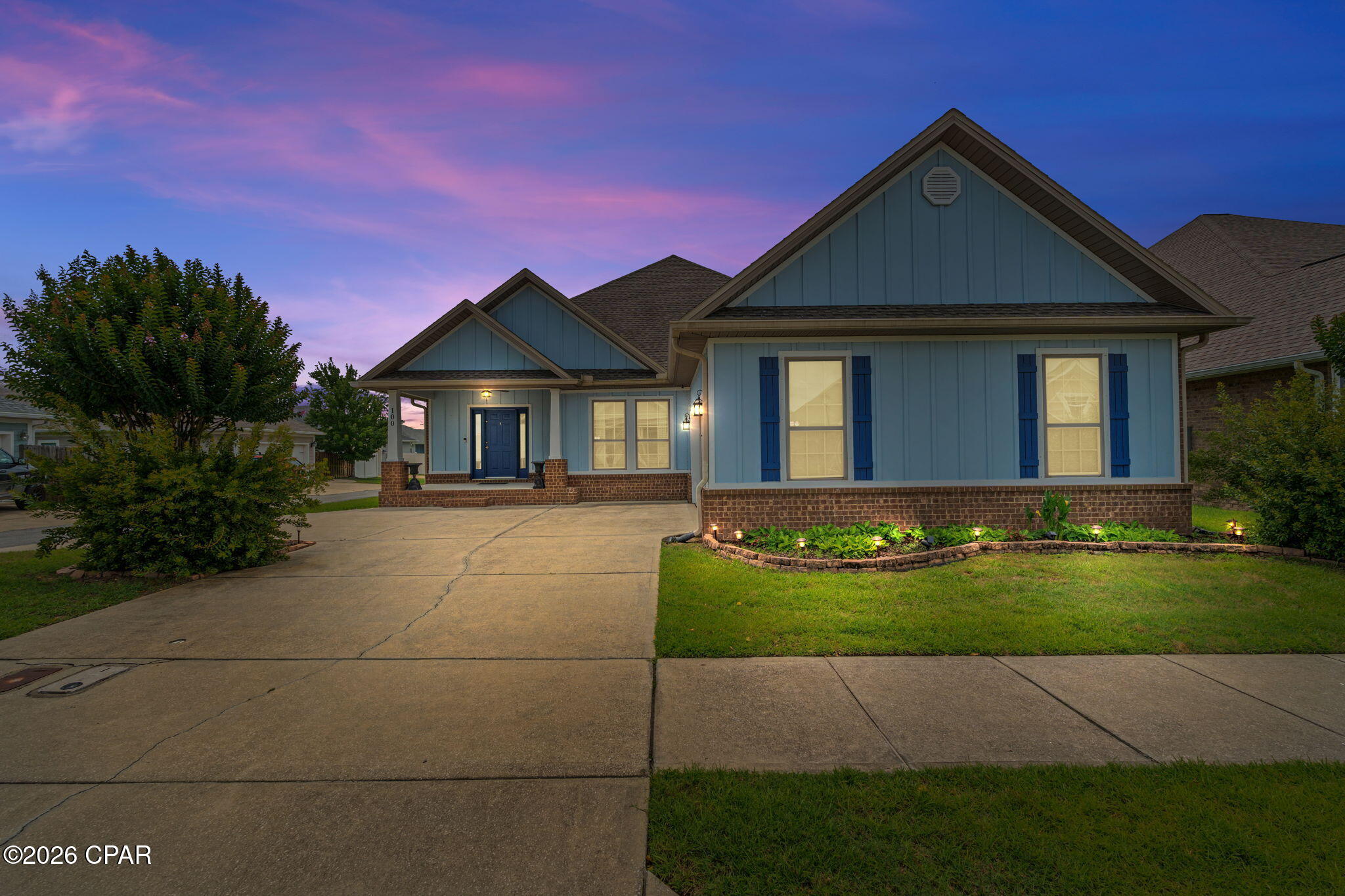 This beautifully maintained 3-bedroom, 2-bath home offers stylish finishes, functional living spaces, and an unbeatable location in the popular Mill Bayou subdivision. Situated on a desirable corner lot, this home features durable Brick and Hardie board siding, covered front and back patios, hurricane shutters, and an inviting outdoor stone fireplace and hot tub perfect for relaxing or entertaining year-round. Step inside to discover light wood-look tile flooring throughout the main living areas, updated light fixtures, and elegant tray ceilings in both the formal dining room, spacious living room, and master bedroom. The open-concept kitchen is designed to impress with granite countertops, tiled backsplash, farmhouse sink, and plenty of prep space for hosting family and friends. The oversized master suite is a true retreat featuring a tray ceiling, large walk-in closet, and a private en suite bath complete with a granite double vanity, a tub/shower combo with tiled surround, and large walk in closet. Two additional bedrooms and a full guest bath provide comfortable accommodations for family or guests. Mill Bayou has a community swimming pool and is conveniently located within walking distance to North Bay Haven Charter Academy. This move-in ready home combines comfort, style, and convenience in one exceptional package!