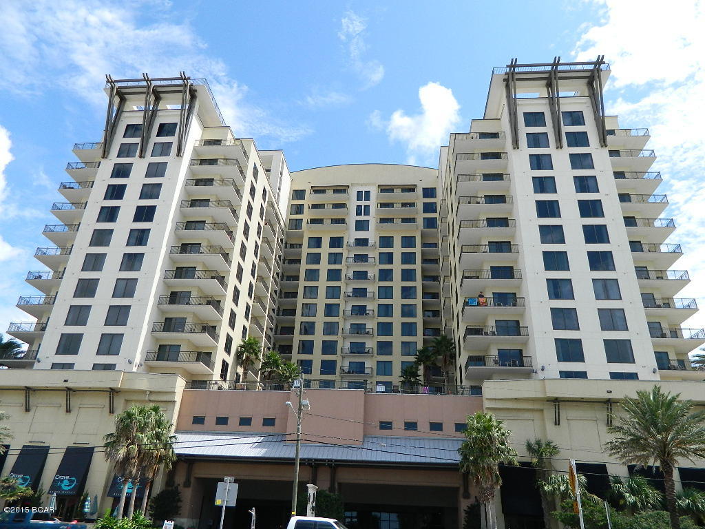 This affordable condo is spacious, newer, in a beautiful building and located directly across from the beach and walkable to a lot of stuff.  The kitchen features granite, black appliances and breakfast bar with pendant lighting.  The large Great Room has a nice high ceiling, is open and accommodates both casual dining and the living space.  The private balcony has both wooded and coastline views.  The Bedroom Suite features a floor to ceiling window with Gulf views. There is a  stackable laundry in the unit as well as laundry facilities off the lobby.  This is a West Indies inspired project with upscale design features.  Covered motor court entrance, luxurious lob and interior corridors with Mahagony entrance doors.