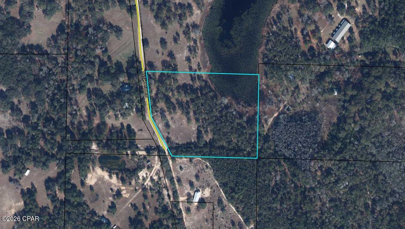 Picturesque 10 acres of unrestricted land. Ready to make this your homesite. Much of the heavy lifting has already been done for you. Has a 20x50 slab for your RV, storage building with AC unit, well, and temporary power pole. Sale will also include a tractor so you can maintain the property. Located off Holmes Valley Road where there are plans for an upscale golf resort. Access to a small pond at the northwest corner of the property. All this property needs is you and your vision for your home.