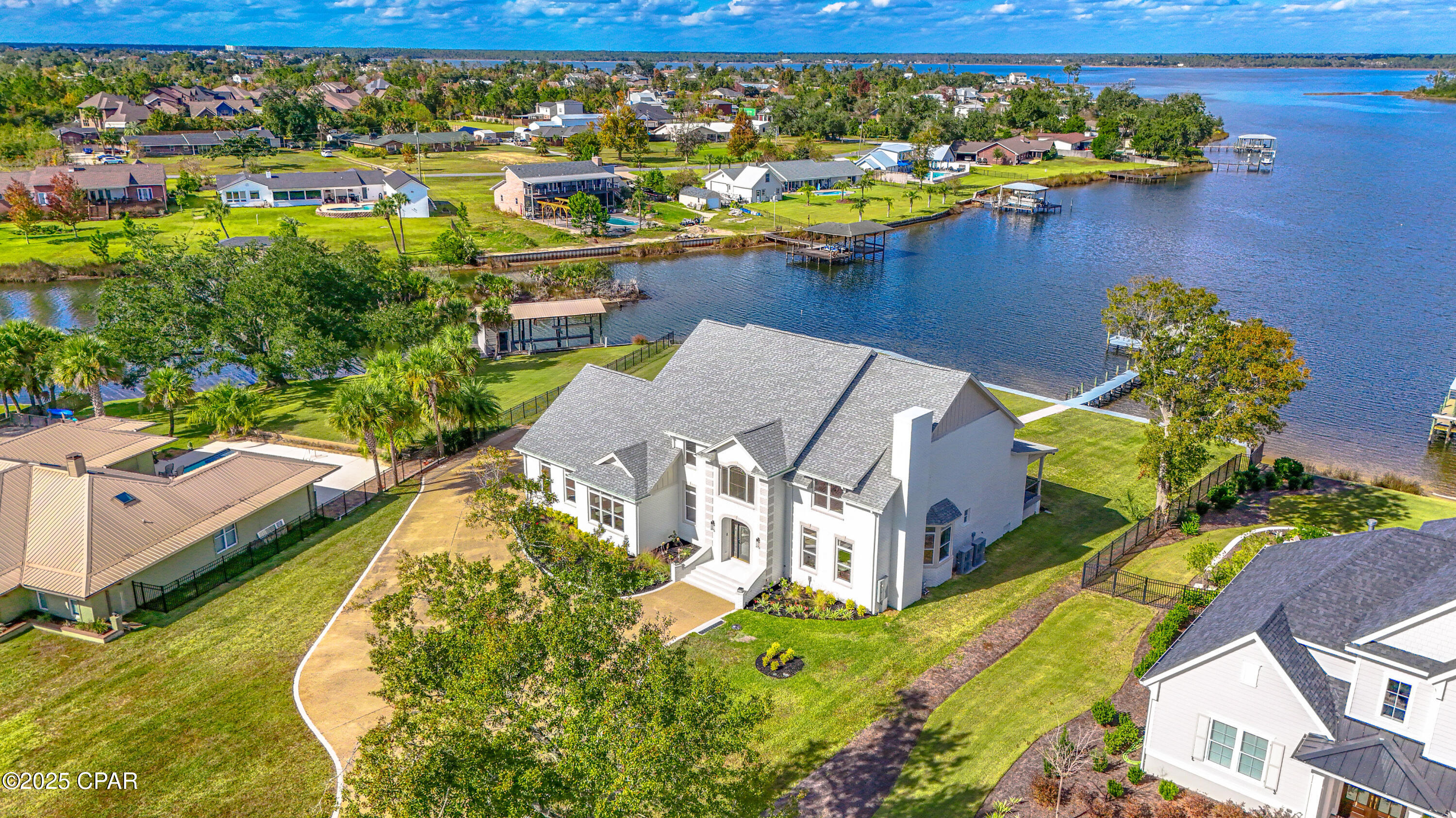 CURRENTLY UNDER CONTRACT, SELLER WILL CONSIDER BACKUP OFFERS.  Stunning and completely renovated down to the studs, this luxurious two-story residence has been reimagined with uncompromising quality and high-end finishes throughout. Situated on a .89-acre lot with approximately 210 feet of deep-water frontage on Mill Bayou, providing direct access to North Bay and the Gulf of Mexico, this property offers an exceptional coastal lifestyle. Enjoy evening sunsets around the gas firepit, relax on the brick-paved patio, and follow the walkway to your private dock and boathouse for quick access to boating and fishing. From the moment you arrive, the home's elegance is undeniable. Step into the impressive two-story foyer with 19-foot ceilings and immediate sightlines through the expansive living room to the water beyond. The living room features a gas fireplace, wet bar with wine cooler, and direct access to the 58-foot covered rear porch, an ideal space to enjoy morning coffee or an evening glass of wine. A den with a gas fireplace sits to the right of the foyer, and a conveniently located powder room is just off the main living area. To the left is the formal dining room, a full bath, and a well-appointed laundry room with Cambria quartz countertops, sink, and abundant cabinetry. The kitchen is a chef's and baker's dream, equipped with premium Thermador appliances, including a custom range hood, Cambria quartz counters and island, tongue-and-groove pine ceilings, tile backsplash, kettle faucet, and a custom walk-in pantry with water and electrical connections for an additional refrigerator. The breakfast area and adjoining living space provide breathtaking panoramic views of the bay. The oversized 3-car garage (37.9 feet deep) accommodates multiple vehicles, storage, or a golf cart. The home is thoughtfully designed with handicap-accessible features, including ramps along the left side into the garage and from the home to the outdoor entertaining area and dock. Two additional main-level bedrooms are located on the right side of the home, one offering beautiful water views. They share a spacious Jack-and-Jill bath with a tiled glass shower and dual vanities. For added convenience, the home provides two staircases, one off the foyer and one at the rear. The second floor showcases an extraordinary primary suite measuring approximately 29' x 15', complete with a sitting area surrounded by windows overlooking the bay. A barn door opens to the luxurious primary bathroom, where no detail has been overlooked: extended Cambria quartz double vanities, abundant storage, a stunning 90-gallon clawfoot soaking tub with water views, an oversized tiled shower with dual showerheads, separate water closet, linen closet, and a utility closet with space for a stackable washer/dryer (in addition to the main downstairs laundry). The double walk-in closet consists of two custom-designed rooms with extensive shelving and cabinetry. Pull-down attic access offers even more storage. The second level also includes four additional bedrooms, two on each side of the home, each pair connected by a Jack-and-Jill bathroom.
In total, the home offers 7 bedrooms, 5.5 bathrooms, and 5,522 heated and cooled square feet (per appraiser).Additional Features Include:• Seawall• Circular driveway• COREtec VP flooring throughout (with tile in select areas)• Four HVAC units (two double-stacked systems) with separate upstairs/downstairs controls• Culligan water filtration system• Visual Comfort lighting• Crown molding in foyer and family room• High-profile baseboards and soft-close cabinetry throughout• Two electric forced hot-water units• Raised cable outlets, timer outlets, and USB outlets• Open-cell insulation in walls and ceilings for energy efficiency; electric bill $120 p/month.  This exceptional property must be seen in person to fully appreciate the craftsmanship, thoughtful design, and luxurious coastal setting. Contact your Realtor today for a private showing before this piece of paradise becomes someone else's reality. Age, square footage, schools, taxes, room dimensions, and any important information are estimates only and should be verified by the buyer through personal or professional inspections.