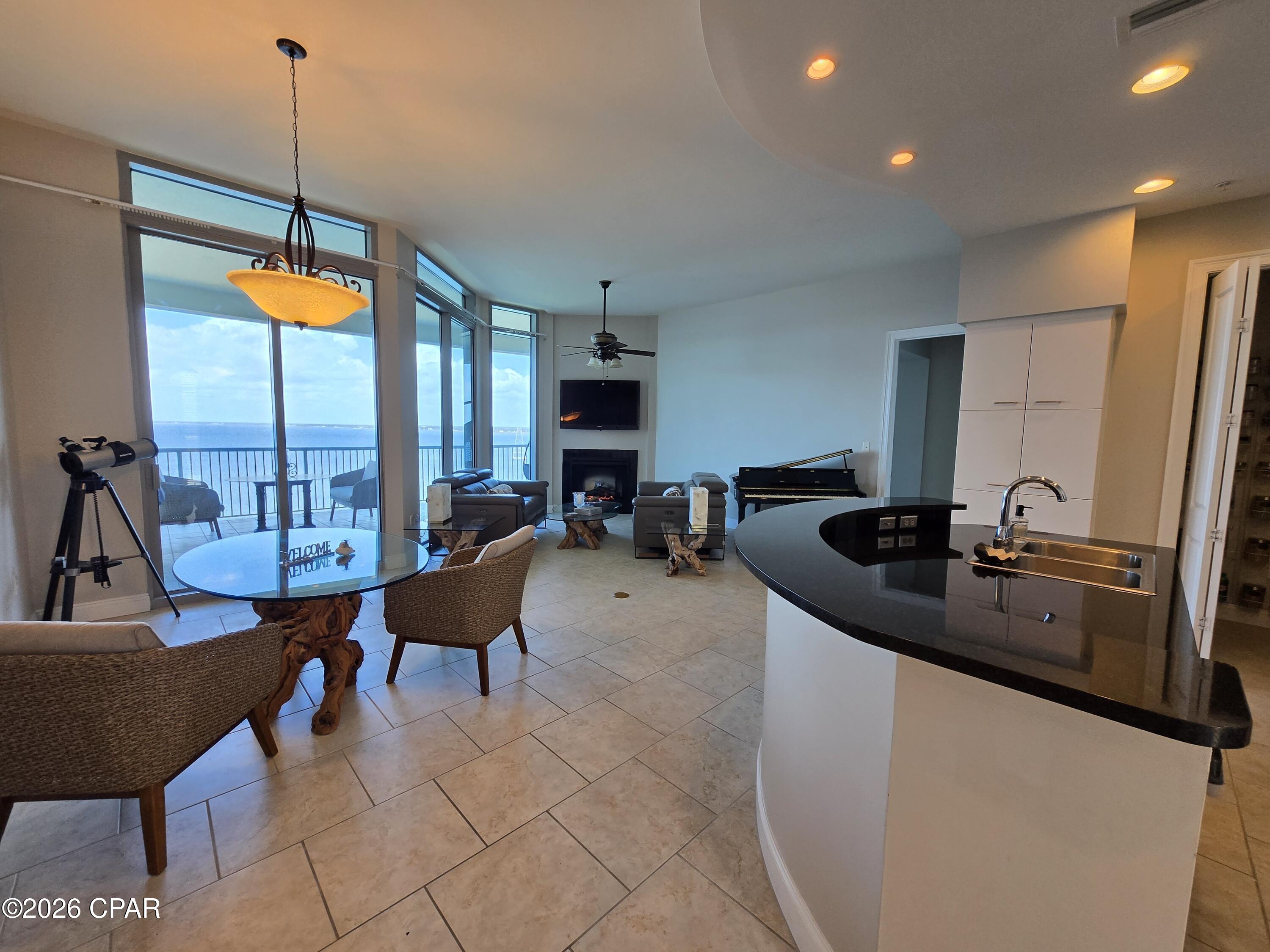 Experience elevated waterfront living in Marina Landing 1403, a beautifully appointed 2-bedroom, 2-bath bayfront residence offering 1,384 square feet of refined coastal comfort. Perched on the 14th floor, this exceptional unit features sought-after penthouse finishes, including higher ceilings and additional windows that flood the space with natural light while showcasing breathtaking panoramic views of St. Andrews Bay from every room. Perfectly positioned at the foot of the Hathaway Bridge, you'll also enjoy a stunning architectural backdrop as the bridge stretches gracefully across the water--especially beautiful at sunrise and sunset.

The open-concept living and dining area is framed by floor-to-ceiling glass, creating a seamless connection to the water and filling the home with stunning scenery and soft bay breezes. The thoughtfully appointed kitchen features granite countertops, stainless steel appliances, abundant cabinetry, a pantry with in-unit laundry, and modern fixtures. A cozy fireplace adds warmth and charm, making the space equally inviting for relaxing evenings or entertaining guests.

Step outside to your expansive balcony--complete with a built-in grill--where nearly 500 square feet of outdoor living space becomes your private retreat. Enjoy unobstructed bay views, spectacular sunrises, frequent dolphin sightings, and the peaceful movement of boats passing beneath the bridge--all from the comfort of your own home.

Both bedrooms are spacious bayfront suites with direct balcony access and walk-in closets, offering privacy and comfort for residents and guests alike. The primary suite features room for a king-size bed and a luxurious en-suite bath with a double vanity, soaking tub, and separate glass-enclosed shower. The guest suite is equally impressive with its own en-suite bath and updated finishes.

Marina Landing offers a serene, upscale lifestyle with resort-style amenities including a bayfront pool and spa, fitness center, resident gathering spaces, picnic areas, a walking path along the water, and access to a dock for kayaking or paddleboarding. The adjacent marina provides convenient options for boat slips, making this an ideal location for boating enthusiasts. A covered, assigned parking space is also included.

With no short-term rentals allowed, this community maintains a peaceful and private atmosphere--perfect for a full-time residence or a relaxing second home. Ideally located just minutes from the beach, dining, and local attractions, Marina Landing 1403 offers the perfect blend of luxury, comfort, and true waterfront living.

Schedule your private showing today and discover the lifestyle waiting for you on the bay.