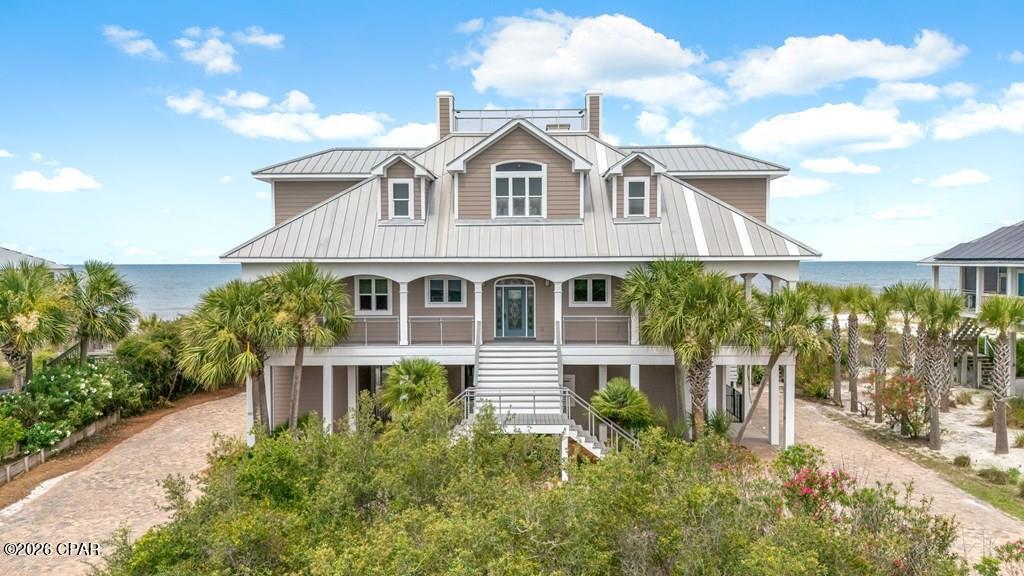 GULF-FRONT | 109 FEET OF BEACH FRONTAGE | PRIVATE POOL Experience the best of Cape San Blas from this custom-built Gulf-front retreat in Secluded Dunes community. Located just one home away from St. Joseph Peninsula State Park's 2,500 acres of protected land, this property offers unmatched privacy, breathtaking views & some of the most spectacular sunsets on Florida's Forgotten Coast. Designed to maximize its stunning waterfront setting, this 4BR/4.5BA home features a reverse floor plan with the primary suite & main living area conveniently located on the top level. Soaring ceilings, expansive windows, Brazilian cherry hardwood floors & an open-concept layout showcase panoramic Gulf views, while bay views can be enjoyed from multiple areas of the home. The gourmet kitchen is equipped with premium Viking appliances, granite countertops, custom cabinetry, double ovens & abundant prep space. A wet bar with wine cooler & beverage refrigerator makes entertaining effortless, while a 3-stop elevator provides convenient access to every level. Outdoor living is second to none with a large private Gulf-front pool, expansive wraparound decking, signature swing beds & a private boardwalk leading directly to the beach. Electronic screens on the primary deck & living area provide comfort while preserving the incredible views. Recent upgrades include brand-new Trex decking, while the brick paver driveway & beautifully landscaped grounds create exceptional curb appeal. Each bedroom offers direct deck access & stunning water views, providing guests with their own private connection to the coast. Additional features include fiber optic internet, public sewer, abundant outdoor living space & the rare combination of Gulf-front luxury with state park privacy. Located on the secluded north end of Cape San Blas, this property is ideal as a luxury residence, vacation home, or investment property.