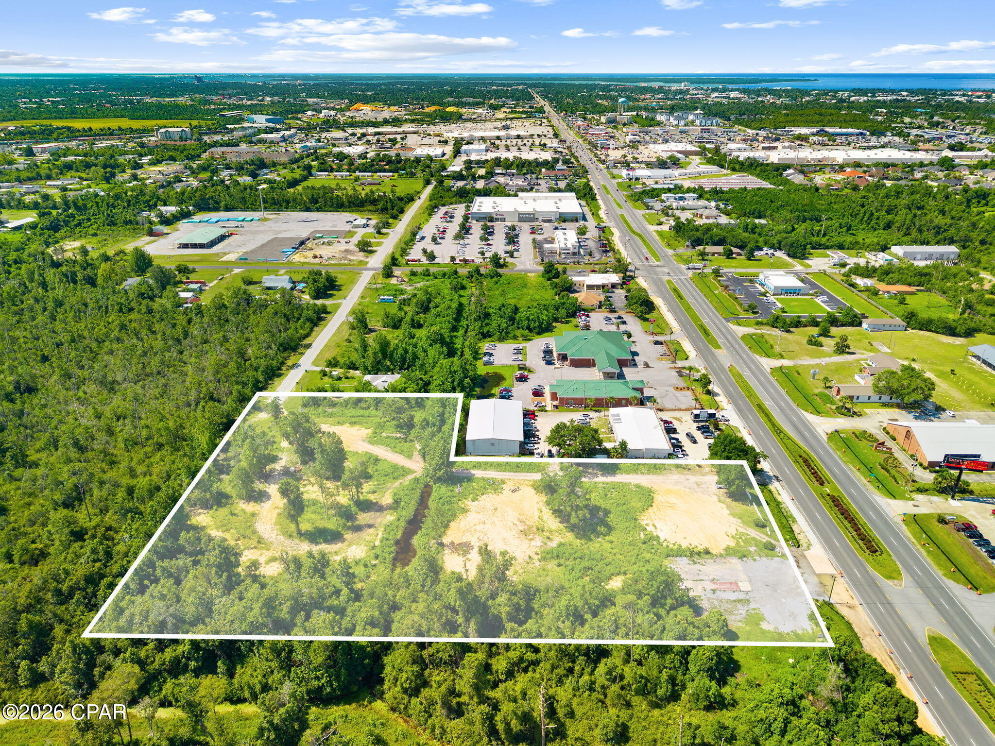 Prime 3.4-acre development site boasting 220 feet of frontage on Highway 77, a major four-lane highway carrying approximately 30,000 vehicles per day (per FDOT traffic count data). This shovel-ready parcel offers rare dual access: a median-cut entry directly off Highway 77 for maximum visibility and customer convenience, plus secondary rear access from N MacArthur Ave for deliveries, overflow parking, or a secondary curb cut. Situated less than a mile from Panama City's primary retail corridor -- Target, Kohl's, Planet Fitness, Home Depot, Lowe's, Walmart, Publix, TJ Maxx, and Hobby Lobby -- this location benefits from established co-tenancy and heavy daily traffic. Ready to build, the site is ideal for retail, medical, restaurant, or mixed-use development. Don't miss this opportunity to secure a high-visibility Highway 77 location with strong frontage and excellent surrounding demographics. Power, Water, and Sewer Available.