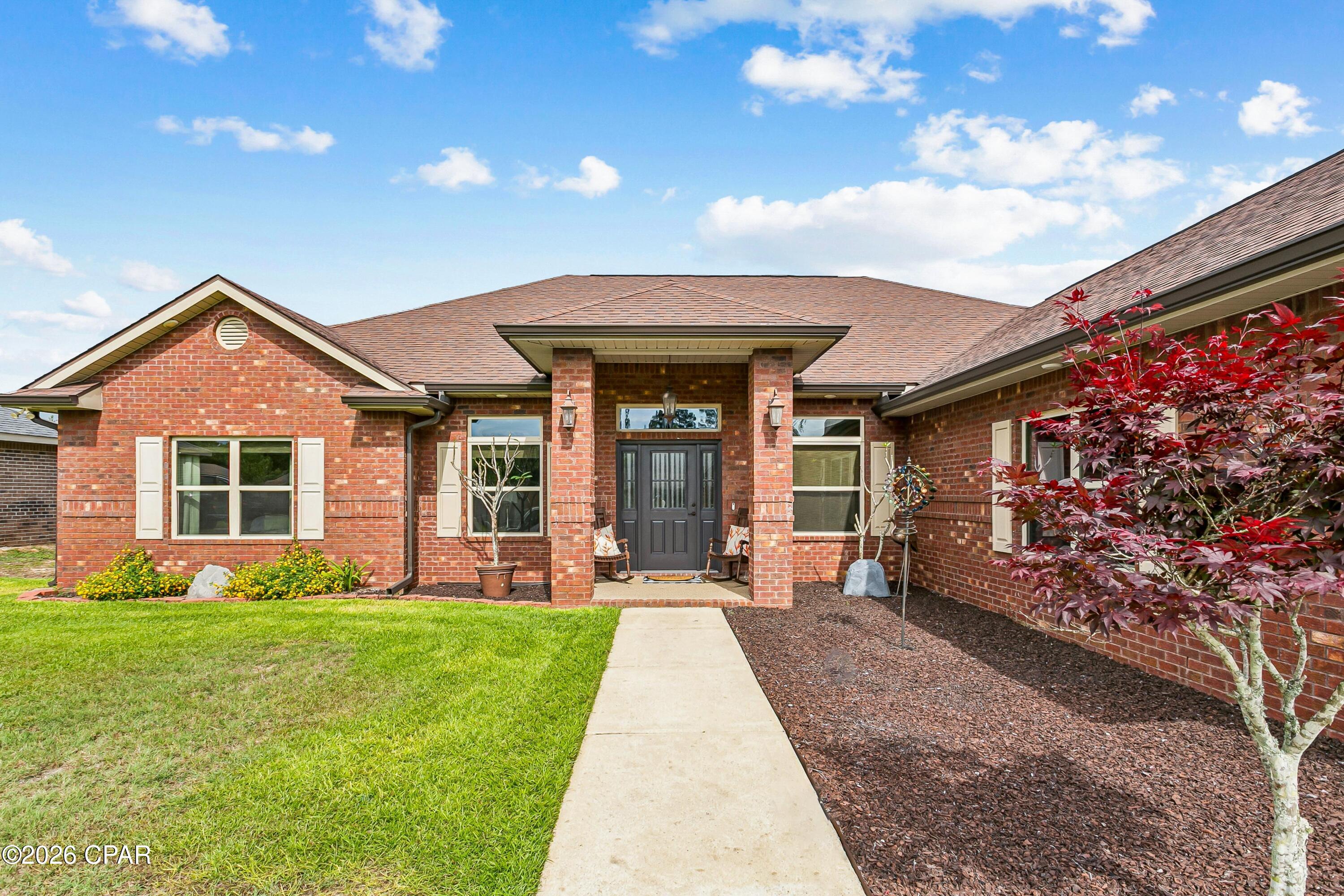 Welcome to this beautiful approximately 2,370-square-foot, three-bedroom, two-bathroom home located in the highly desirable Plantation Woods subdivision in Milton, FL. The kitchen serves as a standout feature, highlighting leather granite countertops, a modern stone backsplash and a double oven vented to the outside. The living area includes upgraded lighting fixtures, built-in surround sound, creating a great setting for hosting guests or enjoying serene evenings at home. The spacious primary suite provides extra seclusion with double-insulated walls, high ceilings, and includes an impressive three-head shower system. Head outside to the screened-in back porch, which features its own speaker system, great for relaxing or entertaining. The front yard landscaping includes rubber mulch. The back patio porch also includes ninja coating tile for a non-slip surface. Beyond the porch, you'll find a large fenced backyard designed for both enjoyment and function, complete with a thriving garden that includes plum and citrus trees, a greenhouse and a newly constructed deck overlooking a cozy firepit area.