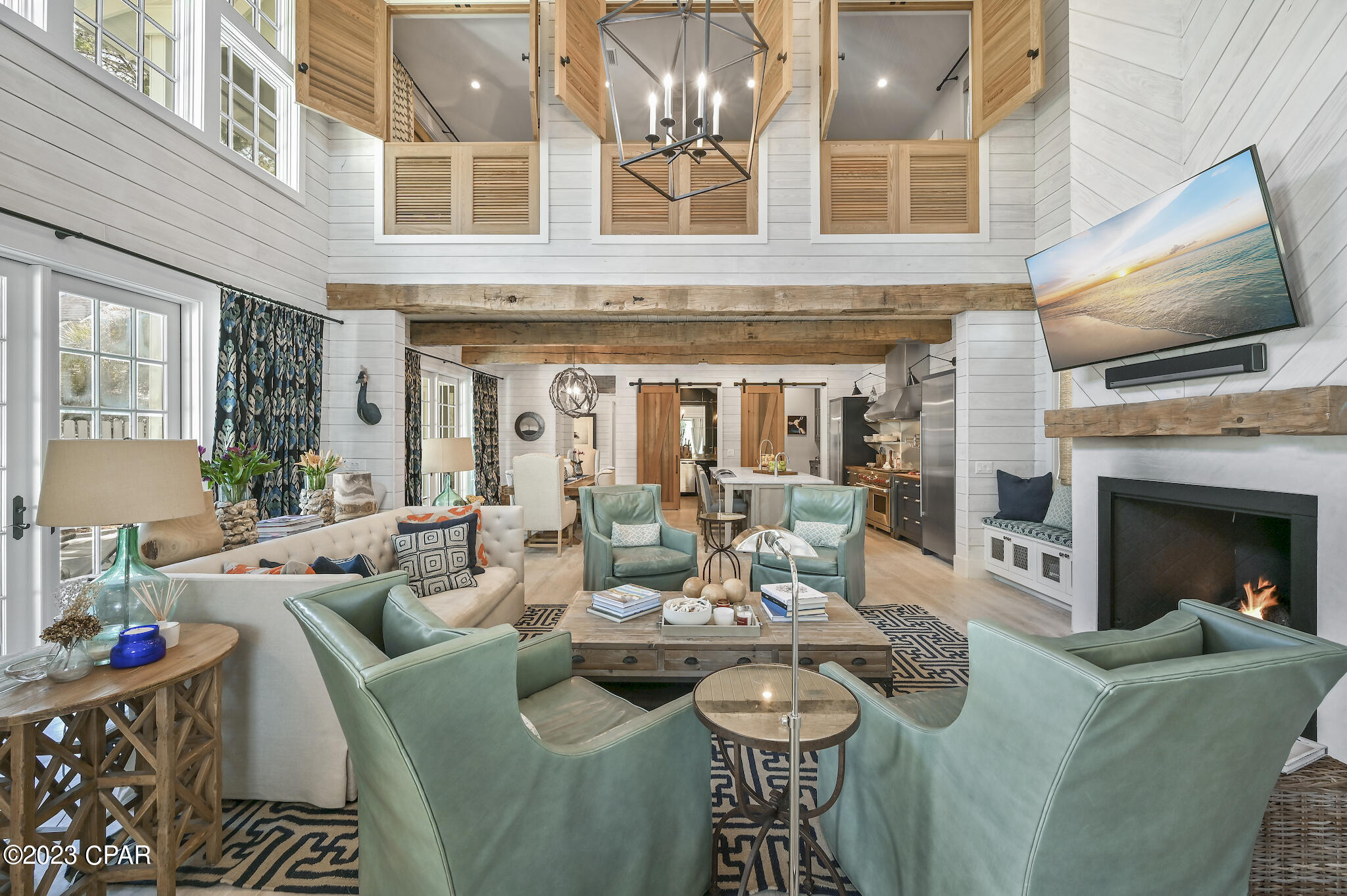 As featured in HGTV and published in 30A Style Book, this casually elegant beach home is situated behind the private gates of Watersound West Beach. Enjoy the ultimate beach lifestyle at St Joe's exclusive Watersound Beach Club, 40K member initiation fee is included at closing. Gorgeous custom beach home promises a relaxed coastal lifestyle where entertaining is warm and welcoming. This 4 bedroom, 3 ½ bath home and guest house features luxury designer touches from Tracery Interiors of Rosemary Beach, and an open-concept design where the indoor and outdoor living spaces meld together without boundaries. The gourmet kitchen is a chef's dream and reflect the owner's deep culinary roots with a massive Wolf gas range, two full-sized Sub-Zero refrigerators, and a walk-in butler's pantry. Two fully equipped wine cellars inside an exquisite bar room tucked behind custom cedar barn doors. Peacock pavers accentuate indoor outdoor living perfectly. The dining area has and array of French doors that swing open onto the pool terrace, while the living room glass doors fold open to allow the space to engage the screened porch for outdoor dining. The second floor of the house is devoted entirely to a generous Master suite with custom cedar privacy shutters, a media chaise lounge, and a luxurious spa bath with wall-to-wall Italian marble, deep soaking jetted tub and standalone his/her showers. There are two guest rooms on the main floor that share a double vanity jack-and-jill bathroom. Designed to maximize privacy, this custom home was designed for guests to have their own luxury space in the carriage house, leaving the main home a sanctuary, opened up for entertaining and pool side gatherings! The private detached carriage house offers another full bedroom, a sleeper sofa and bathroom for your weekend house guests. If you are an electric car enthusiast, the Seller has a built-in charger for a Tesla. West Beach owners enjoy one of the most expansive beaches on 30A, along with nature trails, dog parks and a heated community pool. This house is sold furnished, with some owner exclusions, and can be viewed by appointment only.
