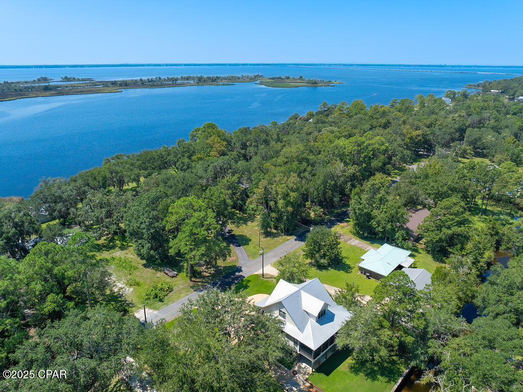 Discover timeless coastal elegance in this exceptional canal-front luxury home where classic Southern architecture meets the tranquility of 'Old Florida' charm. With 130 feet of protected canal frontage and a boat lift, it is an easy boat ride to Choctawhatchee Bay. There is even a 50-amp plug already in place with the extended driveway specifically for an RV hookup. You can relax on the front porch deck while taking in the view of the bay, or settle in on the back screened porch, overlooking the lush yard and canal. This home boasts three stories with an elevator for your convenience. The well-appointed kitchen meets the needs of any chef, with a butler's pantry and plenty of counter space! The open floor plan allows for easy entertaining across the main living areas. This property delivers a rare blend of privacy, elegance, and waterfront lifestyle, an ideal sanctuary for you.