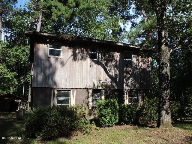 Rustic two story home on slough that goes to Lake Seminole. Lots of work needed to make it liveable. Downstairs is a living room, kitchen, 2 bedrooms and one bath. A sun porch also there but has fallen in. Upstairs is a deck, living/kitchen area, a bedroom and a bathroom. The grounds has a large shed/workshop and a covered area for storage, a fish cleaning shed and a boat house.