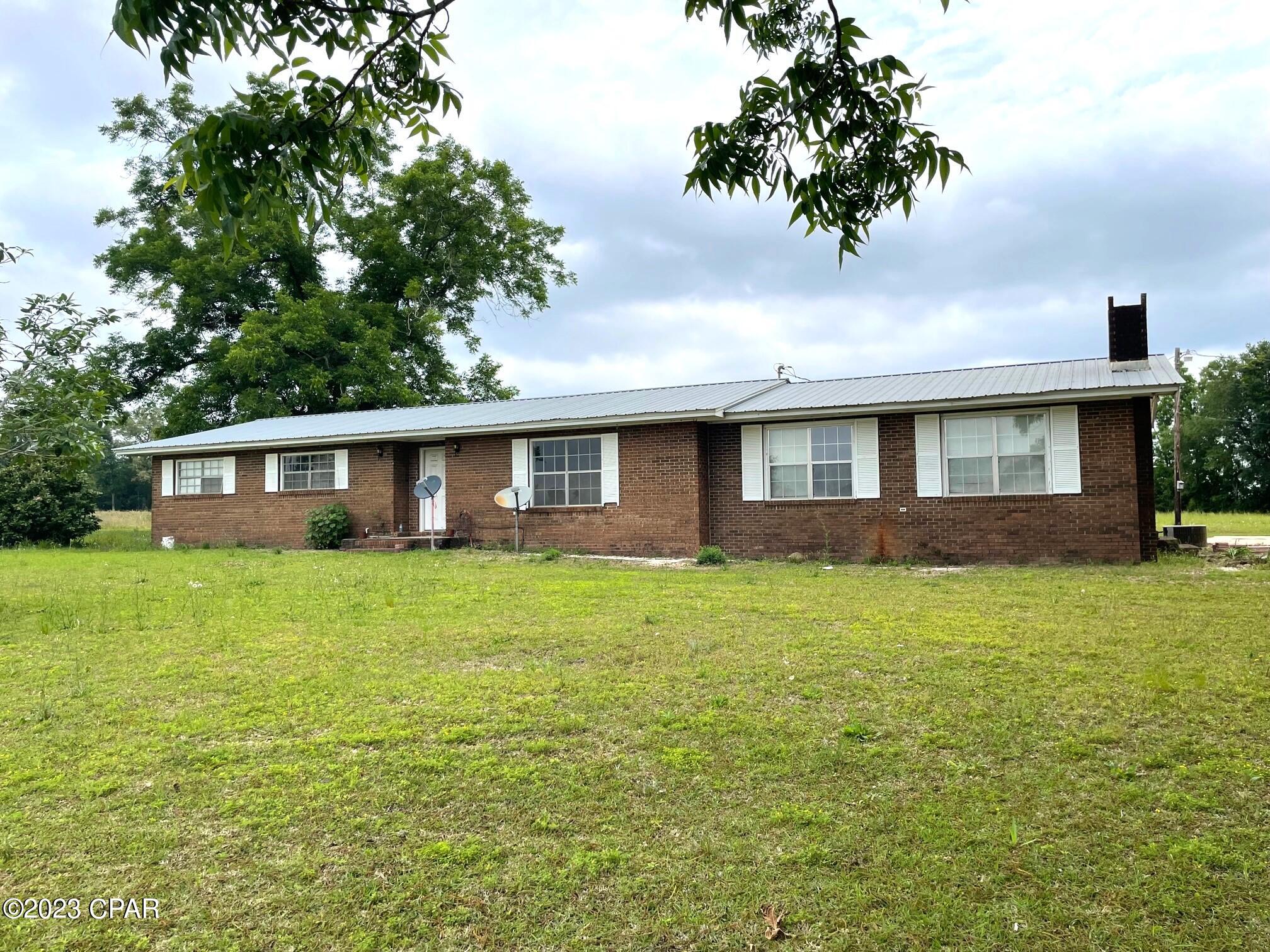 Country home sitting on approximately 7 acres of pasture and pecan trees just outside of Graceville Fl. 3BR/3B, family room and a bonus room with a brick fireplace, 2 AC units, metal roof and more. The home is solid but does need updating with things such as flooring, paint, ect. Could be fixed up to sell or to live in. Bring your horses and enjoy the country life, not to mentioned the fantastic views from this property. Deed restrictions apply.