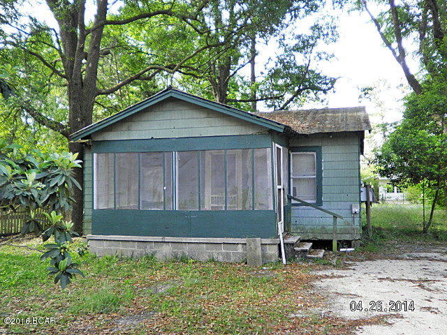 This is a small wood frame house in a great location in the town of Grand Ridge Florida. Located in a good neighborhood, close to food and fuel, post office and schools. This home will make a great fixer upper for someone looking for a small place with a low price. Feel free to drive by or call to see the inside. Ideal rental home in city limits, great potential, needs work, city water and city sewer, wood walls and hardwood floors.