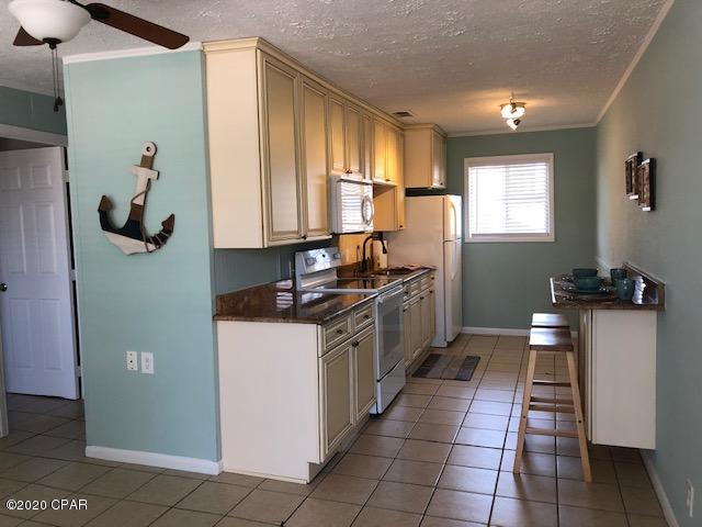 CURRENTLY UNDER CONTRACT, SELLER ACCEPTING BACKUP OFFERS...   VERY CLOSE to ''THE WORLD'S MOST BEAUTIFUL BEACHES'' This 2 bedroom 1 bath Condo with custom kitchen cabinets and granite countertops is located within a mile of the beach - walking distance to the water, restaurants, shopping & marinas.  Close to St Andrews St Park & the Navy Base. Great investment property, retirement escape or vacation retreat!  Condo all on one level, on the 2nd story.  Entire unit just painted.  Property formerly known as  LAZY DAZE CONDO.   HOA includes water, sewer, trash, cable, insurance on the building & lawn maintenace