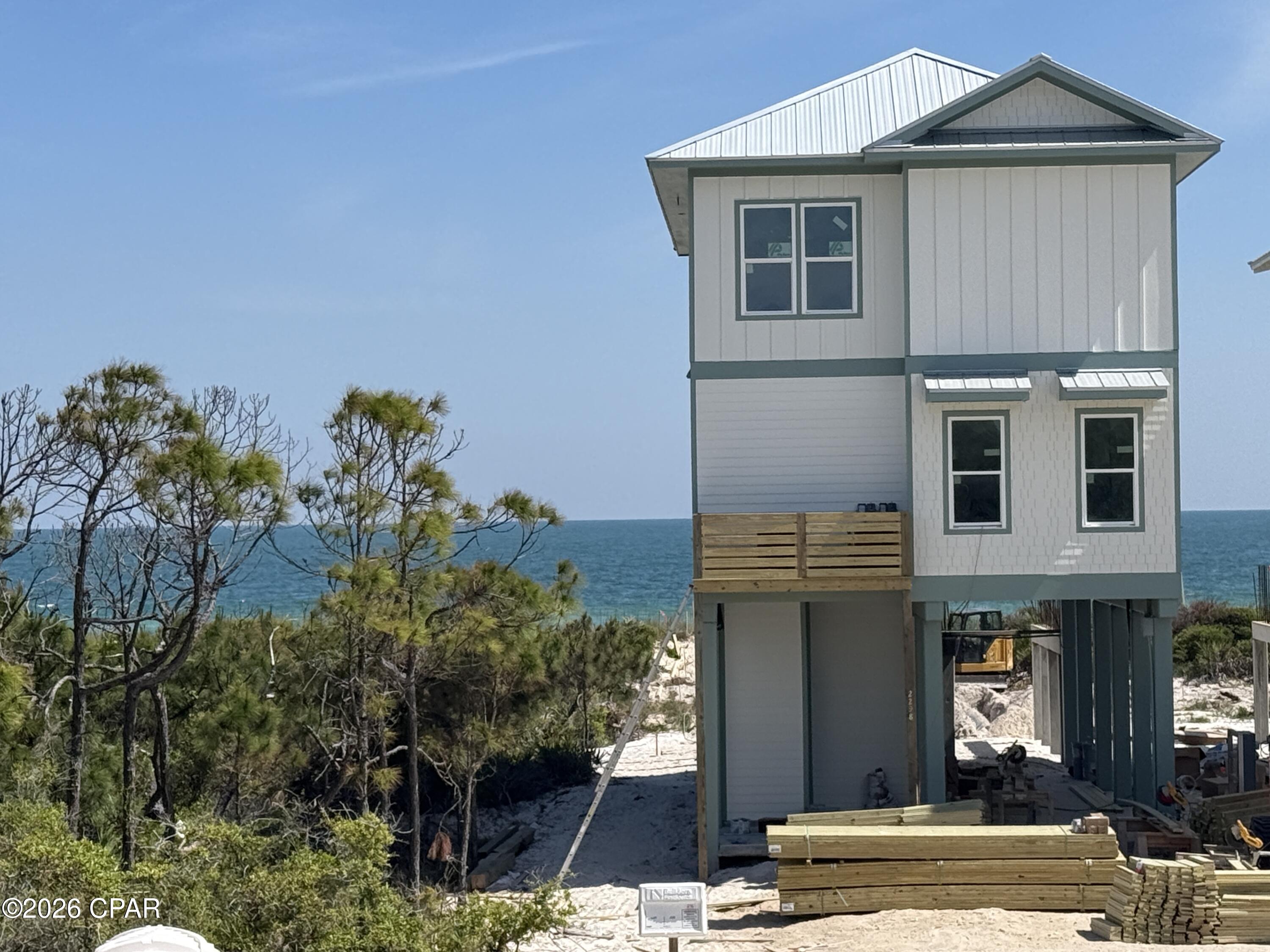 GULF FRONT LIVING AT ITS BEST! Relaxed coastal living reaches a new level at this beautifully designed gulf-front home with direct beach access in Heron's Crossing, a premier enclave within Casa Del Mar at The Plantation on St. George Island. Perfectly positioned along the shoreline, this 4-bedroom, 4-bath residence offers 2,344 square feet of thoughtfully crafted living space that blends luxury, comfort, and the effortless rhythm of island life. Designed for both gathering and unwinding, the open-concept layout is filled with natural light and showcases high-end finishes throughout, including designer cabinetry, premium countertops, and a chef-inspired kitchen complete with a professional-grade range, custom vent hood, and stainless steel appliances. Wide-plank flooring, elevated trim details, and a refined coastal palette create a sophisticated yet inviting atmosphere. Living spaces flow seamlessly to expansive outdoor areas where the Gulf takes center stage. Step outside to your private inground pool, where days are spent soaking in the sun and evenings are defined by breathtaking coastal sunsets. With the beach just steps away, the shoreline becomes an extension of your backyard. Each bedroom offers space and privacy, making this home ideal for full-time living, a luxury vacation retreat, or a high-performing rental. From morning coffee with coastal breezes to evenings filled with the sound of waves, every moment is designed to elevate your lifestyle. Located within the gated Plantation community on St. George Island, residents enjoy pristine beaches, nature trails, and a peaceful, unspoiled coastal setting. This is more than a home--it's a rare opportunity to own a true gulf-front escape and LIVE THE BEACH LIFE. NOTE: Photos shown are from a completed showcase home in the community and are for illustrative purposes only. The featured home shares the same floor plan; finishes and selections may vary.