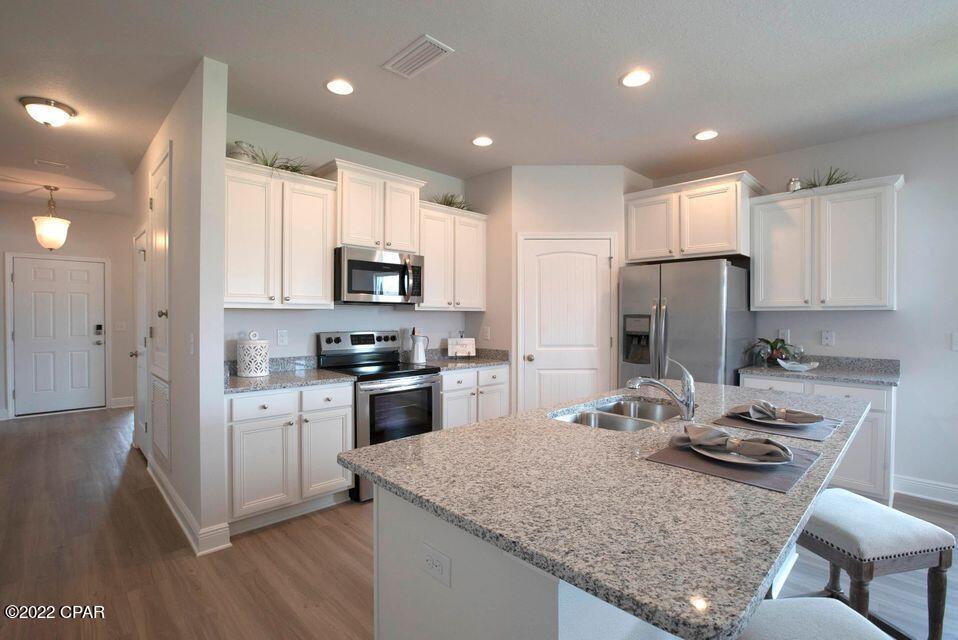 The Kennedy is a charming 4 bed, 3 bath floorplan home located in Windmark Beach with a mother-in-law Suite! Interior features of this home include gorgeous quartz countertops with undermount sinks in the kitchen and bath rooms. Enhanced vinyl plank flooring is throughout the entire home. This home also has Stainless steel appliances including a free-standing smooth top range, microwave, and dishwasher. Windmark Beach is a tranquil community in a natural setting with boardwalks, walking paths, bike trails, roving security and a private beach access. Images, descriptions, SF and room sizes are approximate. Come check this multifunctional home out!