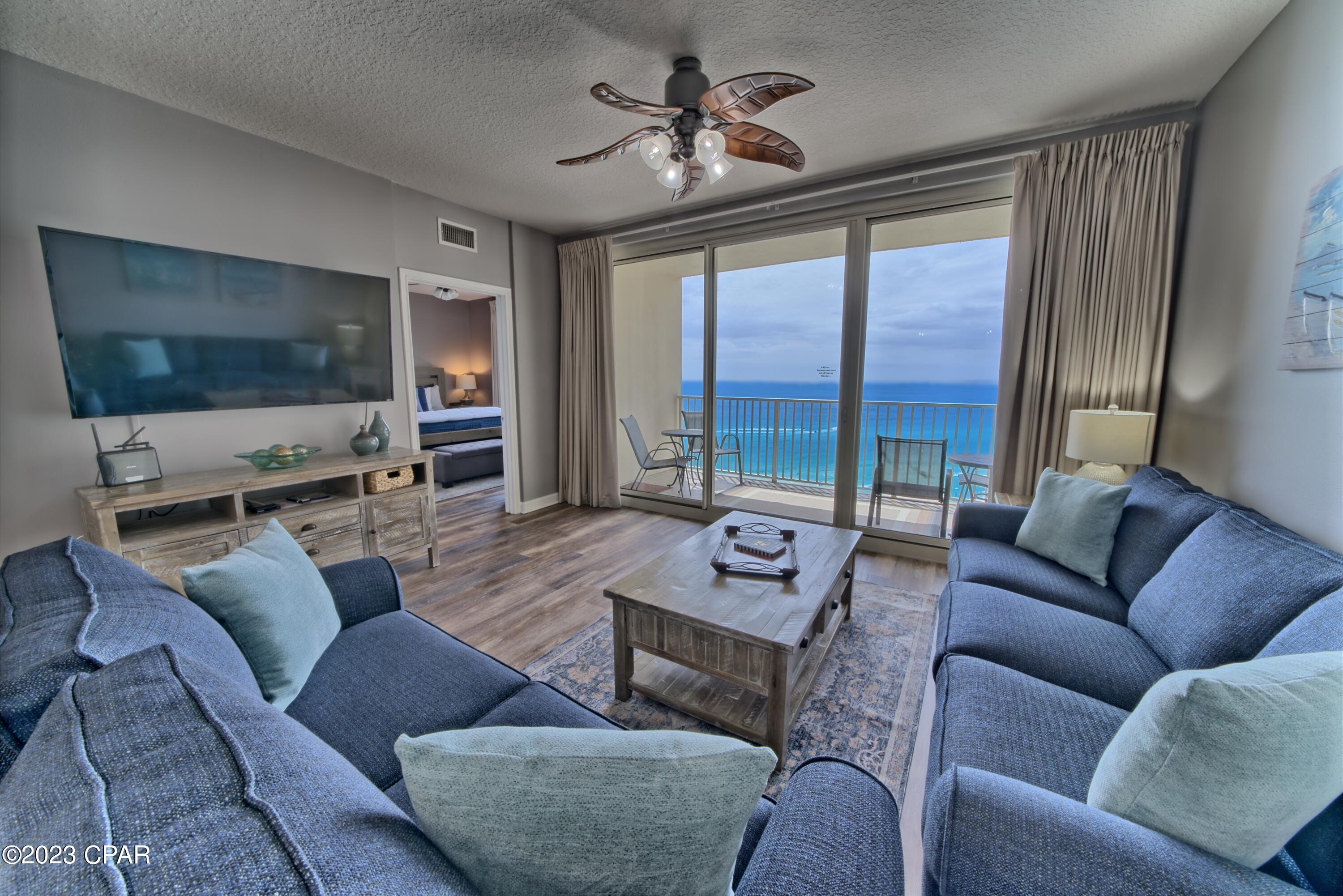 'CURRENTLY UNDER CONTRACT, SELLER WILL CONSIDER BACKUP OFFERS' Stunning custom ''J'' plan (sleeps 8) with only 23 in the building.  Dead on center view with master facing gulf view!  This is your premium customized turn-key money maker at Shores of Panama w/ summer rentals already full!  Complete kitchen remodel includes new island bar, GE Slate appliances, kitchen cabinets, granite countertops, lighting, custom built-in bunks & private door to 3rd bed/bunkroom, newer plank flooring, new furniture-family room & master bedroom, newer HVAC, & water heater, elongated toilets, glass shower doors, & beautiful custom draperies.   2 customized owner closets.  Deeded parking space on 8. You will not find another gulf front turn-key money maker like this! This Unit is already on a popular rental program mostly booked for summer 2023!