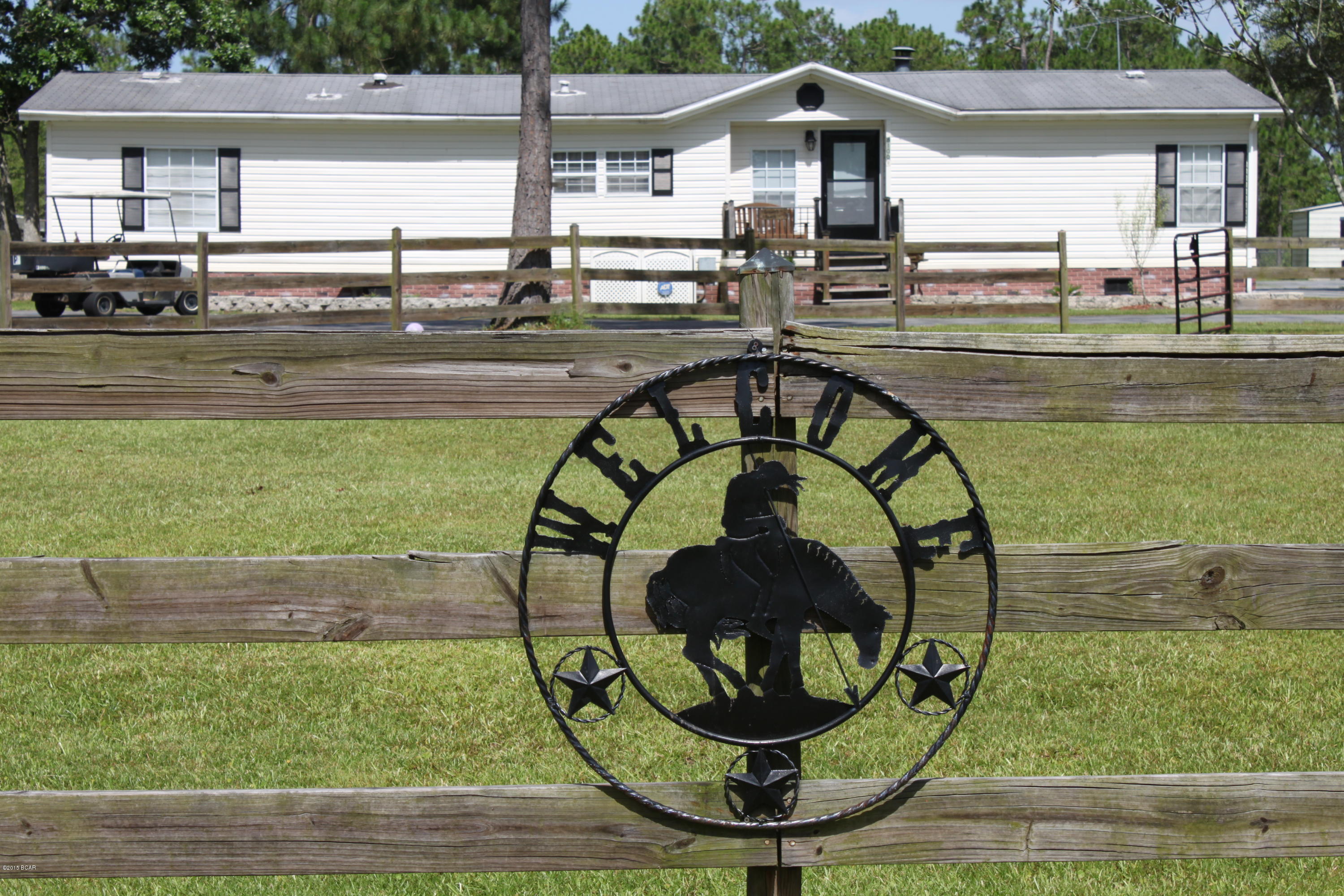 HUGE REDUCTION!!! Have you ever thought about owning a beautiful home in the country, but not too far away from town? Do you want to own enough property that you can have large animals that roam the pastures? How about your own tack and feed room with four stalls for horses? Well then, this is the perfect property for you! Whether you own horses or not you will love this 3 bedroom 3 bath home with it's very own LARGE Game Room, Den or additional Bedroom/ Office. Its screened porch and many covered spaces protects you from the sun while giving you additional outside entertainment space. Lets not forget about its separate two car garage and paved circular driveways with additional paved parking in the rear. Property at this price is 5 acres and 3 parcels.  10 acres available.  See MLS#634090