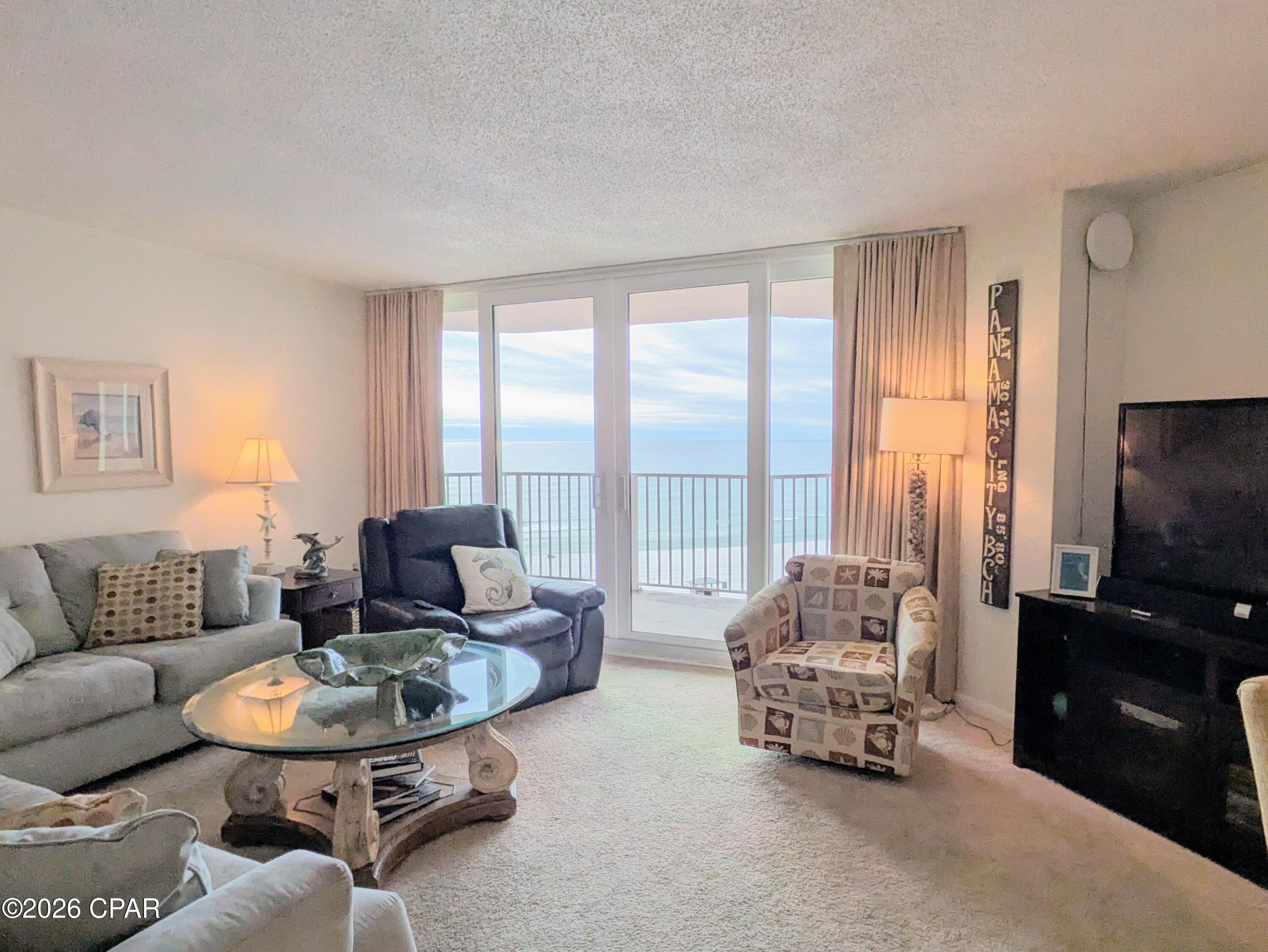 Dunes of Panama E704 - Million dollar views from this perfectly situated 2 bed/2bath, 1,289sq.ft. gulf front condo!  Gulf front balcony spans the width of the condo with perfect Gulf front views from the kitchen, living room, master bedroom, and the balcony also overlooks one of three pools!  Watch endless sunsets from this much sought after, mid-level floor condo. Relax, unwind and enjoy your beautiful piece of paradise!  Also comes with a deeded parking space worth over $15,000 in the gated and secured parking garage with covered access to the entrance of 'E' building.  
Great rental potential or live in your own piece of paradise.  
The Dunes of Panama Resort has 1500 linear feet of sugar white sand, 3 gulf front pools (one heated), four pickle ball courts, one tennis court, free WI-FI, fitness room, shuffleboard, outdoor BBQ grills, Stingray's restaurant and gift shop and the Sneaky Tiki poolside.  
A/C has been recently replaced and Water Heater is 2023.  NOTE: The second bedroom suite, recliner, coffee table, a few small kitchen items and the balcony furniture do not convey.
Has been a non-rental and part time home of the owner so there is no rental history. Similar units generate around $45-$60K annually and can be more.
All dimensions and information herein are deemed reliable but should be verified by buyer.