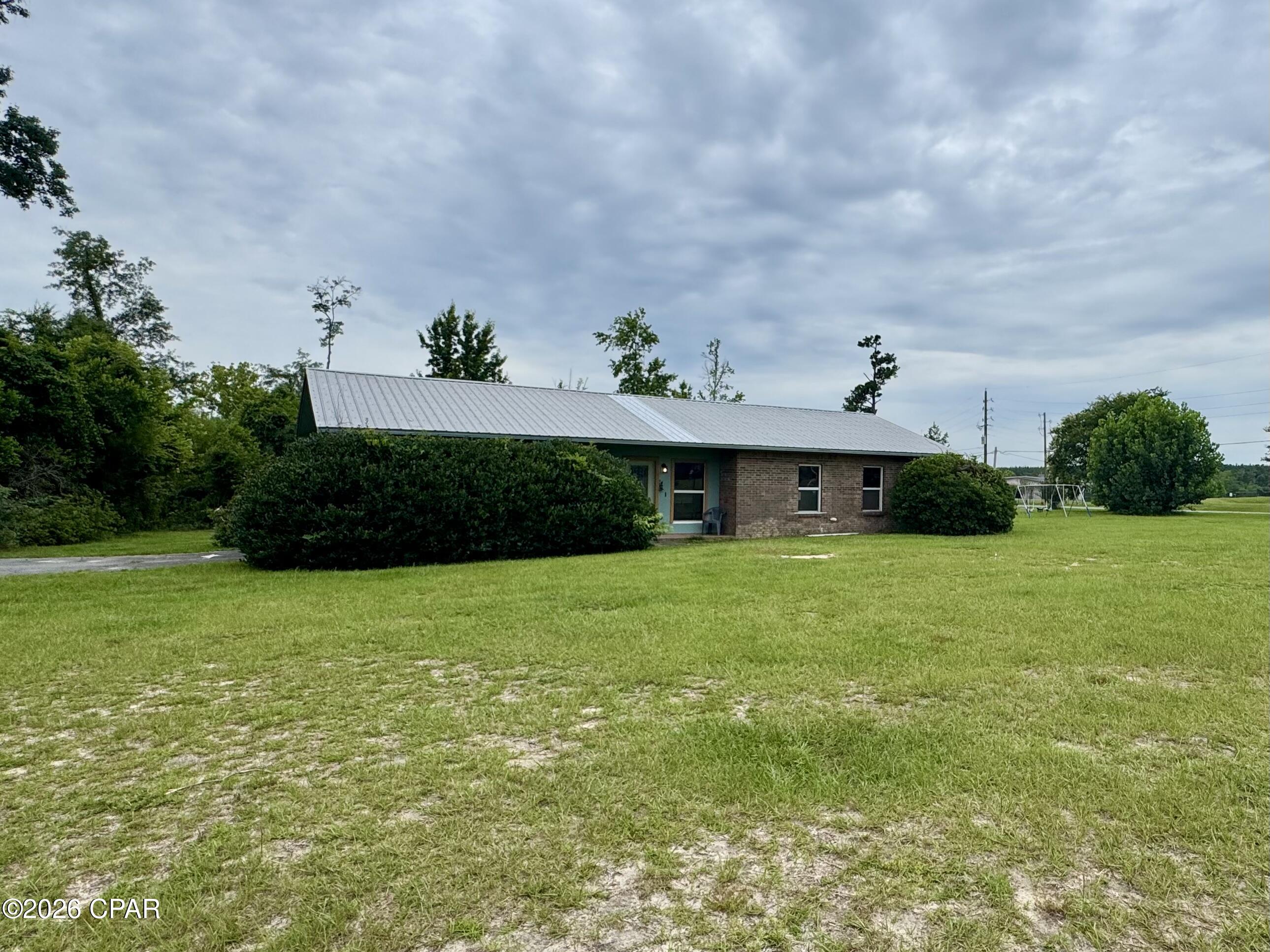This charming 3BR/2BA completely renovated brick home on expansive corner lot is a must see! The home also features an office that could possibly be converted into a 4th bedroom. Enjoy the spacious open floor plan, featuring a large living area perfect for family gatherings or entertaining friends. The cozy fireplace adds a warm touch, making this space inviting year-round. The kitchen boasts modern appliances and convenient breakfast area. The master bedroom offers his and her closets with an en-suite bathroom. The nearly one acre corner lot provides plenty of room for outdoor activities, gardening, and entertaining. The property also includes a 16x20 portable insulated pine cabin that includes electric, window ac, refrigerator. and microwave. There is also a 12x24 shed and chicken coop included. The home is conveniently located near Merritt's Mill Pond, a 200 acre spring-fed lake renowned for its crystal-clear waters originating from Blue Springs in Marianna, FL.
There is an adjoining parcel ID#12-4N-10-0155-0000-0170 that offers .96 acres that will be available for purchase if desired.