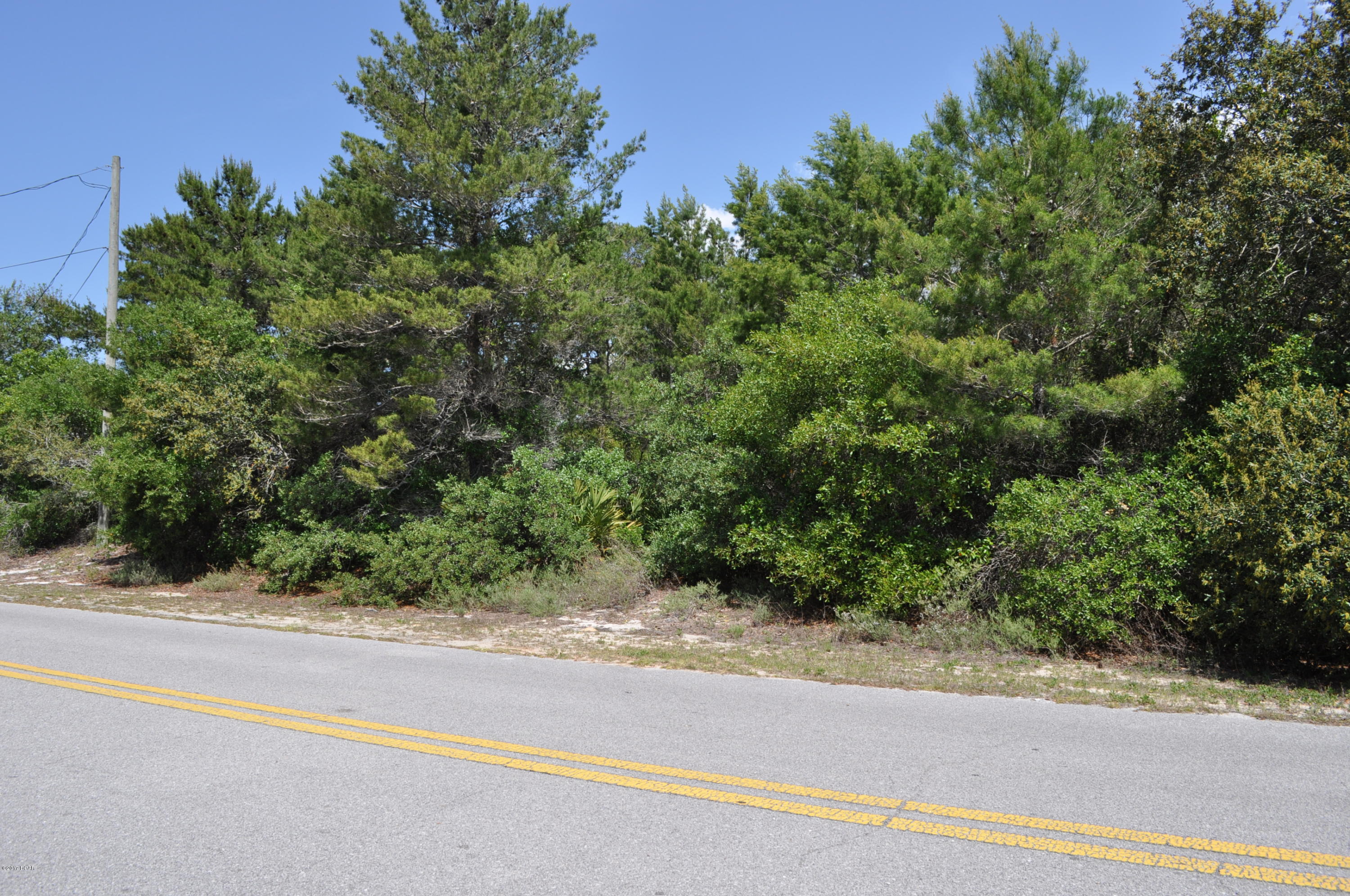 Very large lot on the west end of Panama City Beach with possible view of Lake Powell. This is a 107x161 building lot on a knoll. The sellers say, if you build a two or three story home, you can easily see the lake. There is a gated community with large homes just to the right of the lot.  You're also just a few blocks from the public park and boat ramp on Lake Powell and only 5 minutes from the beach!  All info is approx. and must be verified by Buyers if important.
