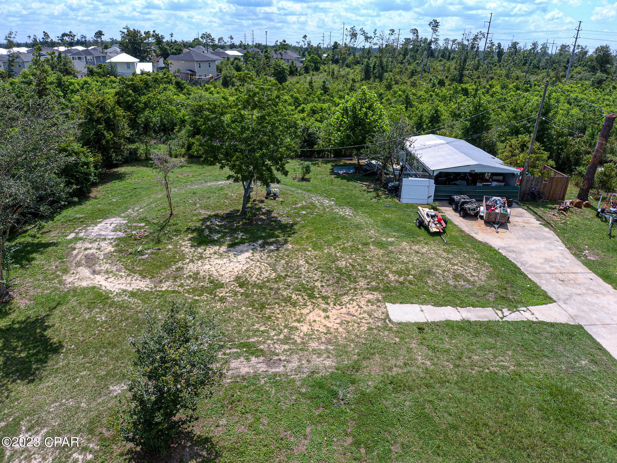 Large cleared double lot centrally located with city water and sewer. Lot had single wide mobile home that has been removed. Features include power pole and main panel, two car carport, large shed/workshop, driveway, trees, and RV hookup. Cleared and ready to set your mobile home on or build your home. Zoned mixed use so you have a few options. Can not have an RV as the primary residence. Call your favorite Realtor® today!