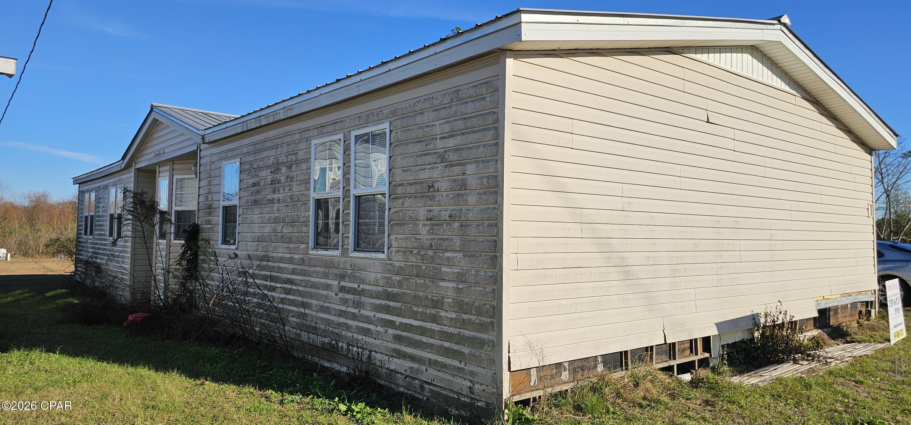 Great Investment Property!! Take a look at this 4 Bedroom 2 Bath 2280 sq ft DWMH. The home needs work but with the right touch this can be a beautiful home! Located on .30 acre on a paved road in Altha Florida. Easy access to Panama Cities most Beautiful Beaches! The home was condemned after Hurricane Michael but with a little remodeling and a new septic tank, the condemning can be reversed according to the county. There is a well already in place and needs to be hooked up. Or sell the mobile home and place or build another home! Call today for more information.