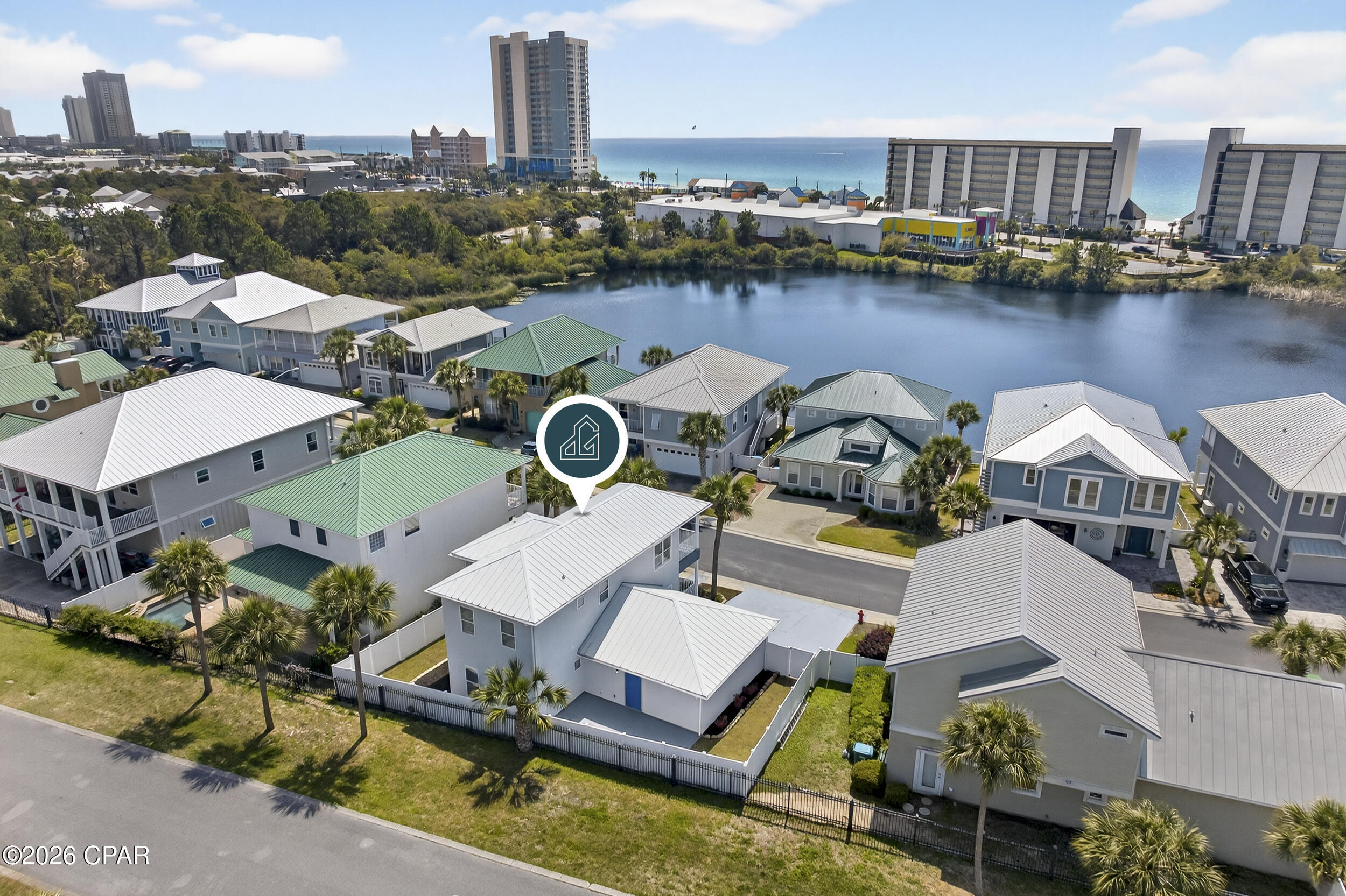 CURRENTLY UNDER CONTRACT, SELLER WILL CONSIDER BACKUP OFFERS. Just steps from the sugar-white sands and emerald Gulf waters, this updated Panama City Beach home offers an exceptional blend of location and comfort - set on a private street just one block from the beach.

Designed for effortless coastal living, this 3BR/3BA two-story home features a bright, open layout with 9-foot ceilings, abundant natural light, and a durable metal roof. Updated 9'' luxury vinyl plank flooring runs throughout, delivering the look of hardwood with the durability and low maintenance ideal for a beach home or rental property. The living, dining, and kitchen areas flow seamlessly, creating a comfortable and inviting space. The kitchen is well-appointed and functional, featuring quartz countertops, a wave-textured backsplash, stainless steel appliances, and a breakfast bar for casual dining. 

The spacious primary suite includes a large walk-in closet and a well-designed bath with a separate shower and tub. A covered balcony creates a comfortable outdoor space to enjoy the coastal setting. Two additional bedrooms - one upstairs and one downstairs - each feature their own ensuite bath, providing privacy and flexibility for guests or family. A 2-car garage adds everyday convenience, while outdoor living is just as inviting with a wraparound porch and a freshly updated backyard designed for enjoying the Florida weather.

Extensively improved by the current owner with approximately $112,000 in upgrades, this home is move-in ready with lasting value. Major improvements include a full exterior stucco refresh, updated HVAC, new fencing, resodded yard, and an enhanced sprinkler system. Additional updates such as new exterior lighting, gutters and downspouts, added outdoor power, fresh interior and exterior paint, updated flooring, and a painted garage floor further enhance both function and appearance. A new washer and dryer add everyday convenience, while the ADT security system with cameras provides added peace of mind.

With its prime location near the beach, modern updates, and flexible layout, this Panama City Beach property is well-suited as a primary residence, second home, or investment opportunity. Schedule your private showing to see it for yourself!