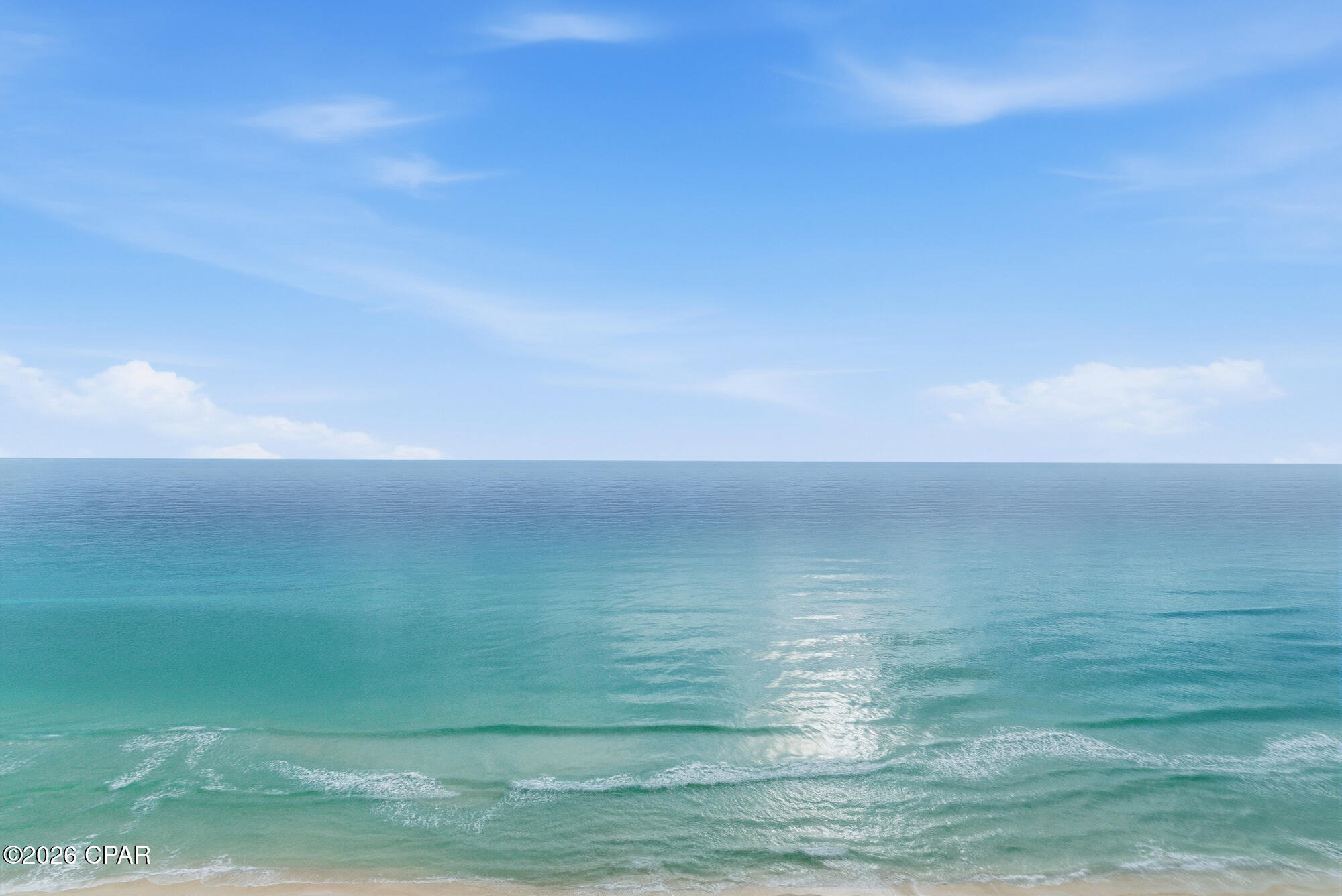 Welcome to Tropic Winds 1806, a stunning Gulf-front condo offering breathtaking views, strong rental opportunities, and the ultimate Panama City Beach lifestyle. Perched high above the sugar-white sands, this beautifully positioned unit delivers panoramic Gulf views from the living area, primary bedroom, and private balcony — perfect for sunsets, morning coffee, and coastal entertaining.

Inside, you'll find a bright, open-concept layout designed for comfort and functionality. The living and dining areas flow seamlessly into the kitchen, creating a welcoming space for gathering after a day at the beach. Floor-to-ceiling windows and sliding glass doors flood the unit with natural light and showcase the endless Gulf views that make beachfront living unforgettable.

The primary suite offers direct balcony access and serene water views, creating a true retreat. Additional sleeping space allows for flexibility for guests and vacation rentals. Step outside to your private balcony and take in the sights and sounds of the Gulf — a front-row seat to paradise.

Tropic Winds offers desirable amenities including beachfront pool, hot tub, fitness center, covered parking, and direct beach access. Located in a prime area of Panama City Beach, close to dining, shopping, Pier Park, and entertainment, this condo is ideal as a primary residence, second home, or high-performing investment property.

Beachfront living doesn't get better than this — schedule your private showing of Tropic Winds 1806 today.