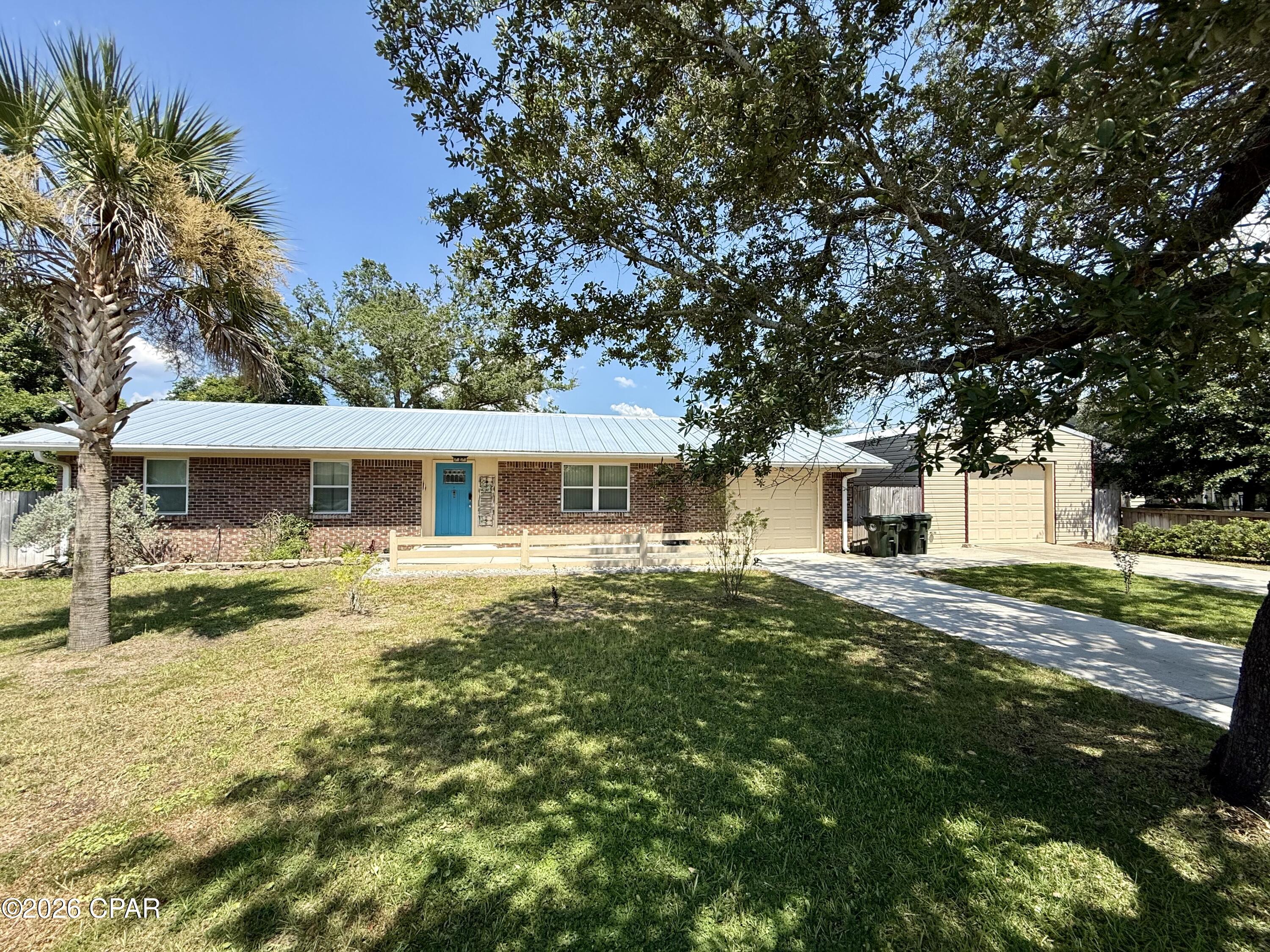 COMING SOON - NO SHOWINGS
Stunning Updated Brick Home with Water Views, Massive Workshop & Prime Lynn Haven Location
Welcome to this beautifully maintained 3-bedroom, 2-bath all-brick ranch nestled in the heart of Lynn Haven. Situated on an oversized 0.36-acre lot in a quiet, established neighborhood, this exceptional property offers water views on two sides, mature shade trees, fruit trees, vibrant landscaping, and an incredible detached workshop that's unlike anything else on the market.

Inside, you'll find a thoughtfully updated interior featuring tile flooring throughout, a beautifully remodeled kitchen with quartz countertops, stainless steel appliances, and updated cabinetry, creating the perfect space for everyday living and entertaining. The spacious primary suite offers a luxurious retreat with a walk-in tiled shower and an updated vanity.

One of the home's standout features is the heated and cooled Florida room, providing additional living space that is perfect as a second family room, game room, home office, or year-round entertaining area.

Step outside to enjoy your own private backyard oasis. The fully privacy-fenced backyard is shaded by mature trees and features beautiful flowering plants and fruit trees, creating the ideal setting for outdoor gatherings, gardening, or simply relaxing.

Need extra space? You'll love the impressive 20' x 42' detached garage/workshop. The 20' x 22' insulated and finished craft room is spray foam insulated, climate-controlled with its own air conditioner, professionally painted, equipped with bright LED lighting, and even includes convenient floor outlets--making it perfect for sewing, crafting, woodworking, a home office, or a hobby space. The remaining portion of the building offers a spacious single-car garage complete with an epoxy-coated floor and dedicated driveway.

Additional highlights include: All-brick construction, Metal roof installed in 2023, Oversized 0.36-acre lot, Heated and cooled Florida room, Updated kitchen and bathrooms, Tile flooring throughout, Privacy-fenced backyard, Mature shade trees, flowering landscaping, and fruit trees, Incredible detached garage and workshop

This one-of-a-kind property combines updated finishes, flexible living space, an extraordinary workshop, and a peaceful setting in one of Lynn Haven's most desirable locations. Whether you're looking for room to entertain, pursue your hobbies, or simply enjoy the beauty of nature and nearby water views, this home truly has it all.