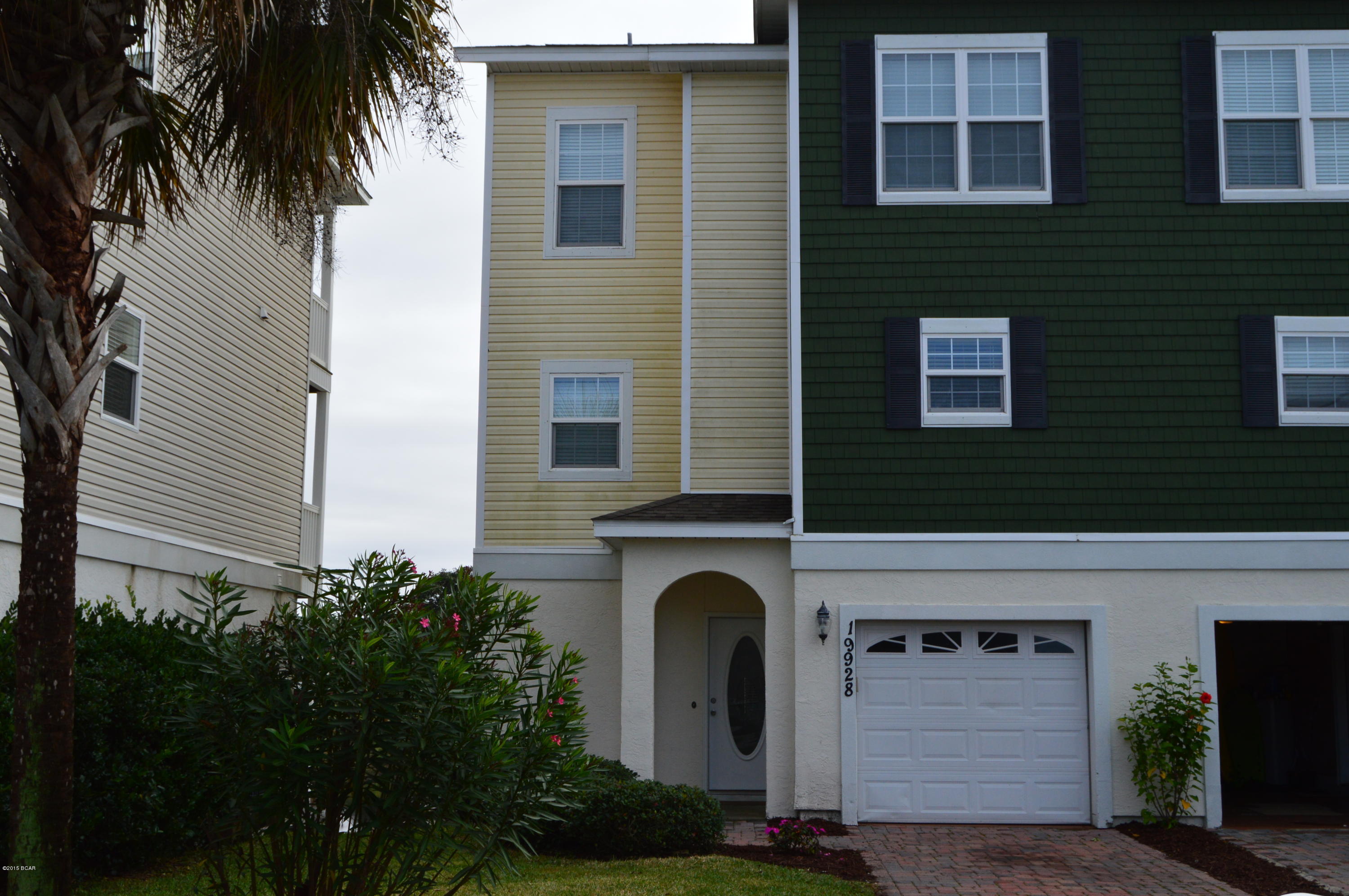 THIS IS YOUR CHANCE! New opportunity to own a waterfront 4 bedroom 3 bath property with three different balconies overlooking a large spring fed pond with views of the Gulf as well.  Freshly painted and brand new carpet! This attached home shows great! NO HOA FEES! First floor features a lockout unit with a separate bathroom and mini kitchenette counter top. The pictures do not do it justice! Show your customers this home!