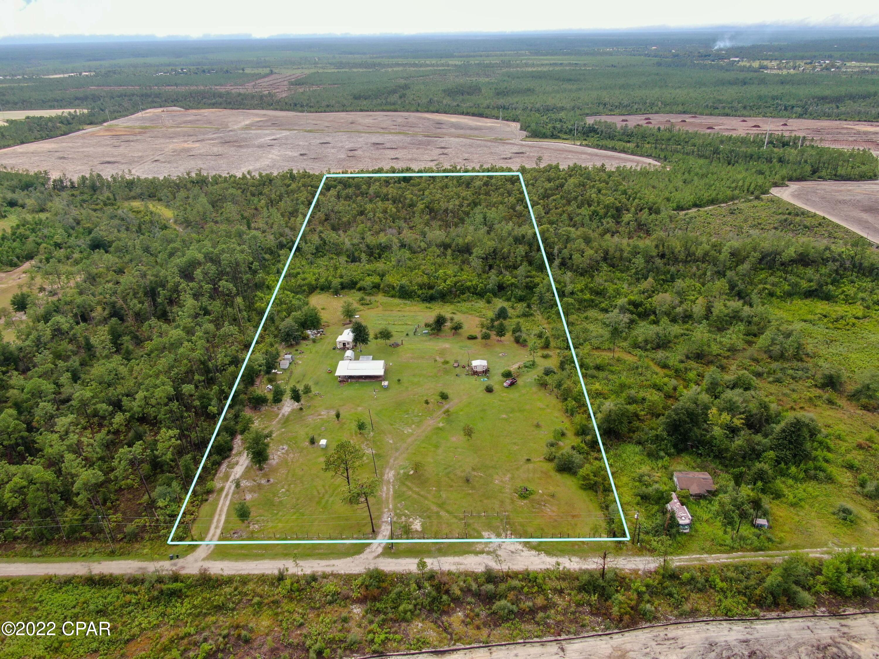 Large 10 acre property located close to major cities but still far enough away for peaceful living. The Front half of the property has been cleared. 4 sheds are included with the property. Large wrap around front porch to enjoy the outdoors. Well and septic for low cost of living. Come build or bring you dream home today! This is your opportunity to home stead on an amazing piece of property!