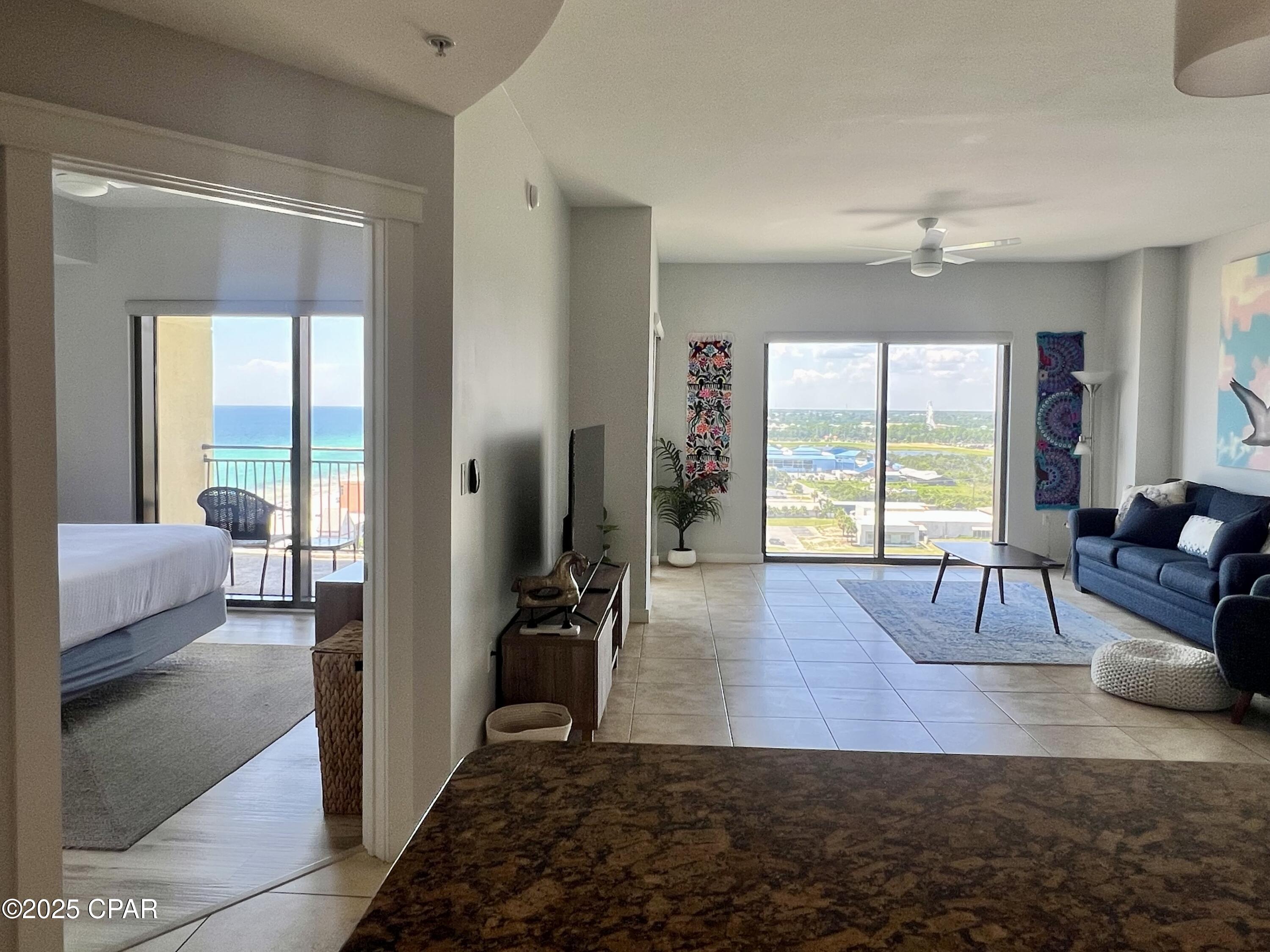 Here is an amazing 1 bed 1 bath condo at the beautiful Origin resort.  Totaling 881 square feet with stunning Gulf and nightly sunset views!  As you enter, you can't help but to notice the beautiful west facing views of the beach, Pier Park, and the Front Beach strip.  Unit 1307 comes fully furnished and is ready to move into or rent right away.  This is the largest living area of any of the 1-bedroom floorplans at Origin.  Plenty of room for a murphy bed, large sectional couch, or office space.  The large kitchen is fully equipped down to the pots and pans and silverware.  No carpet in the entire unit, ceramic tile and luxury LVP throughout!  The bedroom has a king size bed, and stunning views of the Gulf.  There is also a queen sleeper sofa in the living room to accommodate a total of 4 guests.  The bathroom has an upgraded vanity, and a tile surround tub/shower combo and is accessible from the main living area as well as the bedroom.  The balcony offers incredible beach and Gulf views, complete with nightly sunsets!  Freshly painted throughout, including all the trim, newer furniture and decor, and the hot water heater has been recently replaced.  Whether you're looking to make this condo a primary residence, a personal vacation destination, you can travel stress free without a car and walk to some of the area's best restaurants and night life.  The renowned Sharky's beachfront bar and grill is just across the street, Pier Park is less than a mile away, and the new Top Golf is just over 1/2 mile to the west.  Origin offers many amenities including two BBQ grill/picnic areas, a heated pool, hot tub, theater, game room, laundry facility, vending, a gated community with 24-hour security, Beaches and Cream convenient store and grill, and Sunsations beach store. Origin is also one of the very few condos on the beach that offers interior corridors that will keep you feeling safe and secure and out of any inclement weather.  If you're looking to add your investment portfolio, or you're ready to make the world's most beautiful beach your primary (or vacation) residence, call me anytime to schedule your private showing of this amazing condo and the incredible Origin resort.
