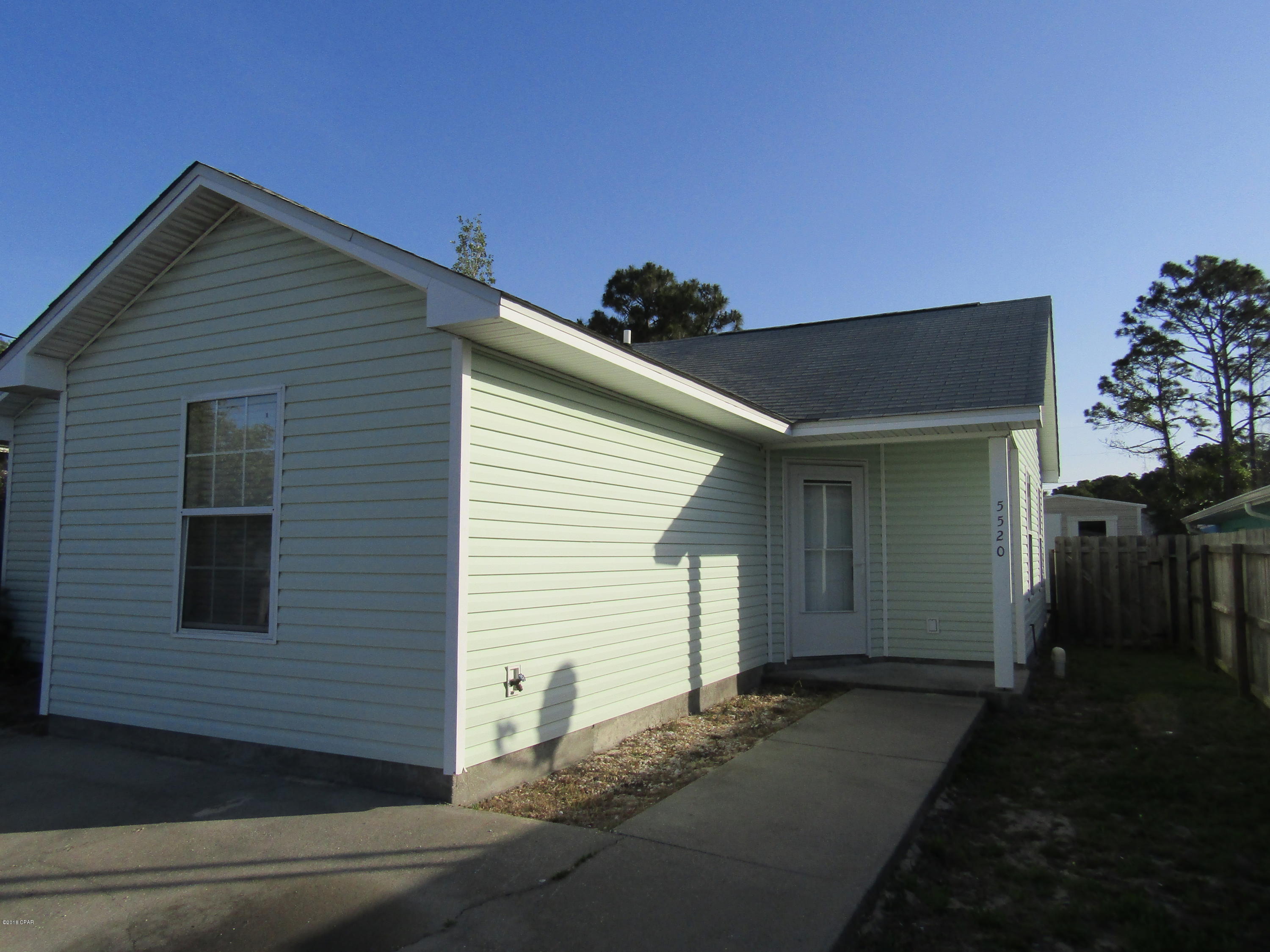 Walk to the beach! 2 bedroom, 2 bath Duplex, tile flooring through out, new blinds, freshly painted interior, includes full size washer & dryer ''AS IS'', partial fence and storage shed in back. Property is on septic system.