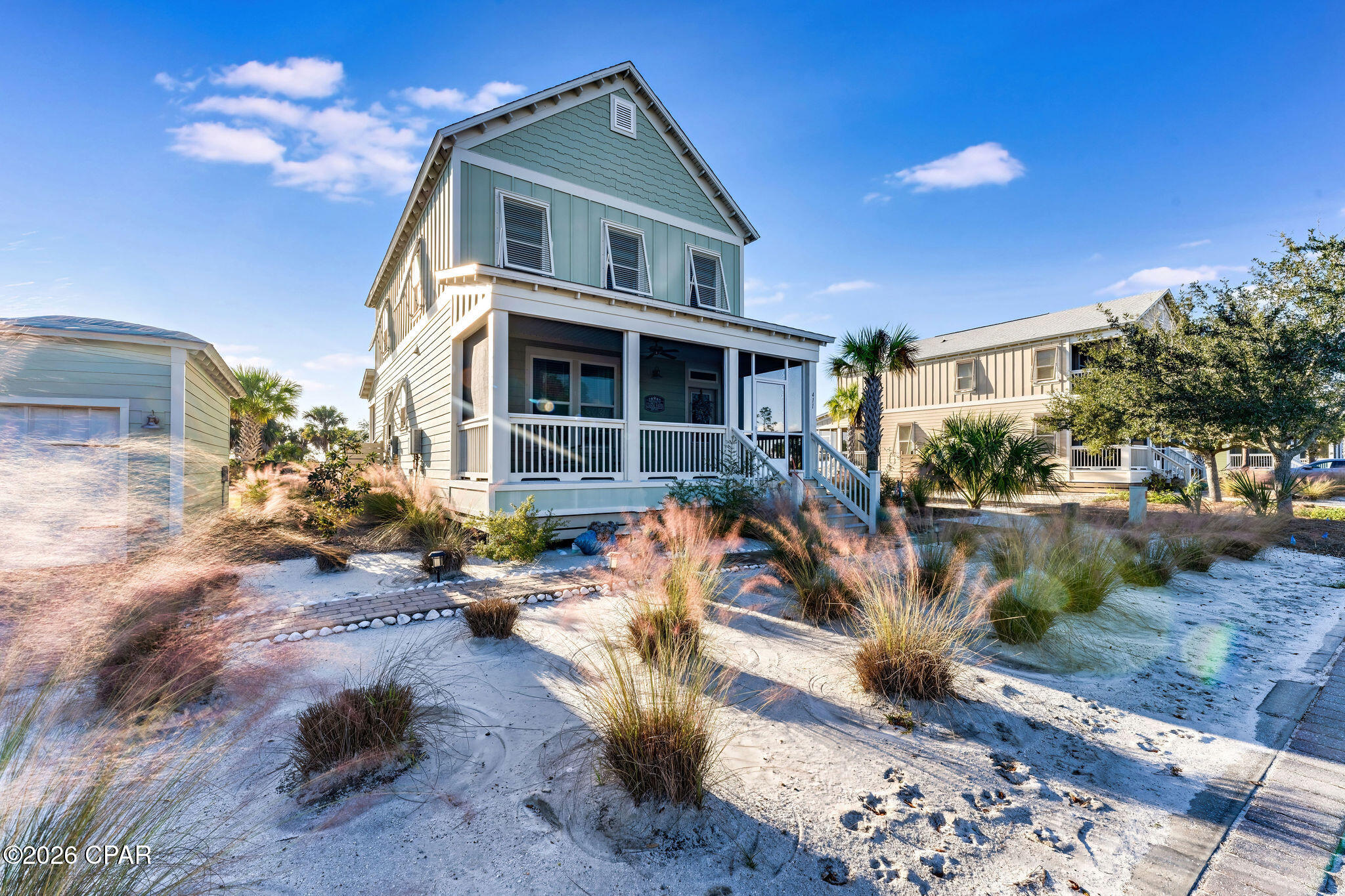 Wake up to sweeping bay views, coastal breezes, and the effortless elegance of this exceptional four-bedroom, three-bath home in WindMark Beach. Thoughtfully designed with luxury finishes and multiple outdoor living spaces, this bayfront retreat blends resort-style amenities with the privacy of your own backyard sanctuary. All tucked right by the HOA maintained boardwalk for quick and easy beach access. A welcoming screened front porch with rocking chairs leads into a light-filled, open-concept interior featuring soft coastal-inspired décor, a spacious living area with a 65'' smart TV and an expansive kitchen with high-end appliances, eat in breakfast bar, and a dining area for eight. Additionally queen size bedroom and full bath reside on the first floor. Upstairs the primary suite offers spacious room for a king bed, complemented by a reading nook and private bath. Additionally, two more bedrooms upstairs reside for guests. Outside, sunset cocktails on the screened back porch swing and peaceful bay-view moments become part of everyday life. The fire pit area is the perfect setting for relaxing evenings, while the outdoor shower makes washing off from the beach a breeze! Don't miss the detached garage with parking for two cars and storage for all your beach gear. Just beyond your doorstep, enjoy WindMark's scenic boardwalks, zero-entry community pool, playground, dog park, and Main Street shops, all within easy reach. More than a home, this is a complete coastal lifestyle where luxury, recreation, and unforgettable family memories come together in one remarkable bayfront setting.
