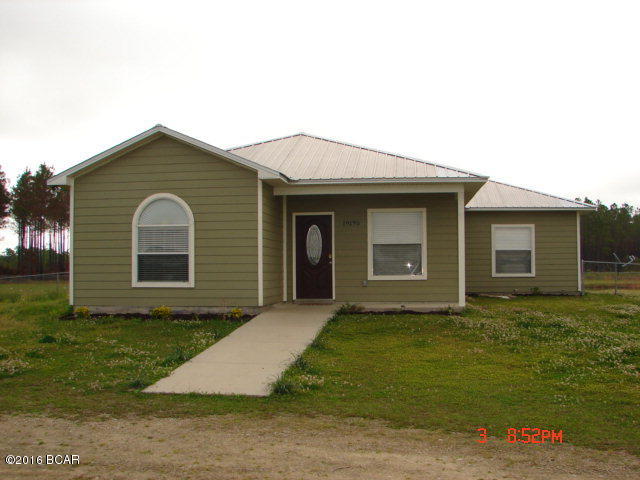 Custom built home less than four miles from Altha on 3.25 acres. The kitchen has stainless appliances, granite counter tops and a beautiful backsplash. This home has four bedrooms and a nice screened in back porch which overlooks a chain link fenced back yard with a pond and outdoor shower. The custom features are too many to list so it is a must see!