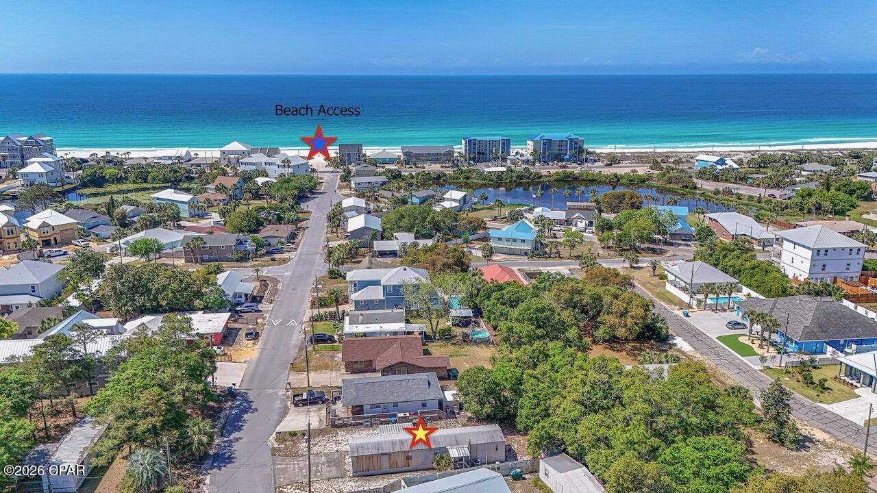 Just over a block from the beach, this 2-bedroom, 2-bath mobile home offers coastal living with water views right from the front yard. Enjoy the convenience of being only moments from your doorstep to the sandy shoreline. The home features a covered porch perfect for relaxing, a two-car driveway, and an outbuilding for extra storage. Whether you're looking for a weekend getaway, investment property, or the perfect spot to build your dream home with a beach view, this property presents an exceptional opportunity to own a slice of coastal paradise.