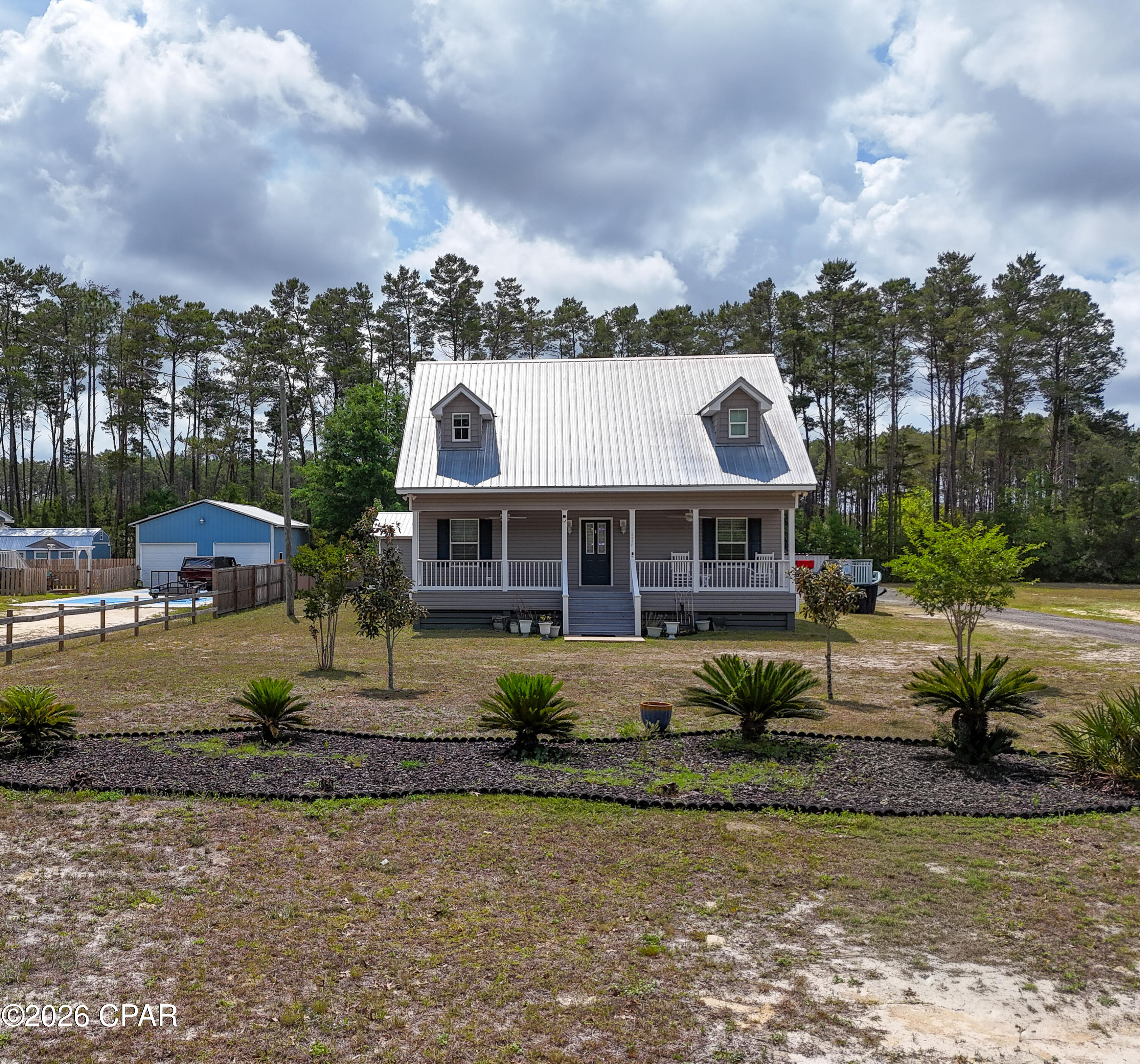Welcome to your private coastal retreat, where comfort meets functionality and every detail is designed for entertaining and enjoying the outdoors. Built in 2017, this beautifully maintained 3-bedroom, 2.5-bath home offers an ideal layout with the primary suite, spacious living area, kitchen, laundry, and half bath all conveniently located on the first floor. The main home features warm pine flooring that adds character and a timeless coastal feel throughout. Upstairs, you'll find two generously sized bedrooms and a full bath--perfect for guests or family.

Step outside and the property truly shines. Expansive front and back porches invite you to unwind, while the thoughtfully designed outdoor living space is made for hosting. Enjoy a cooking pavilion, dedicated bar area, and hot tub--creating the ultimate setting for gatherings after a day on the water.

Fishing enthusiasts will appreciate the deeded private access to a boat launch and fishing dock on Black Creek, with direct access leading out to Choctawhatchee Bay. Whether it's an early morning cast or sunset cruise, this location delivers.

The property also features a detached mother-in-law suite complete with its own bedroom, kitchen, lounge space, and full bath, finished with durable and stylish oak flooring--ideal for guests, rental potential, or multigenerational living. Additional highlights include covered parking for two, a walk-in cooler for your fresh catch, and a backyard dotted with lemon, olive, peach, and fig trees.

All of this, just 20 minutes from the sugar-white sands of Grayton Beach and 25-35 minutes to premier shopping and dining at Sandestin and Destin Commons. No HOA!

This is more than a home--it's a lifestyle centered around coastal living, effortless entertaining, and quick, convenient access to some of the area's best boating and fishing waters.