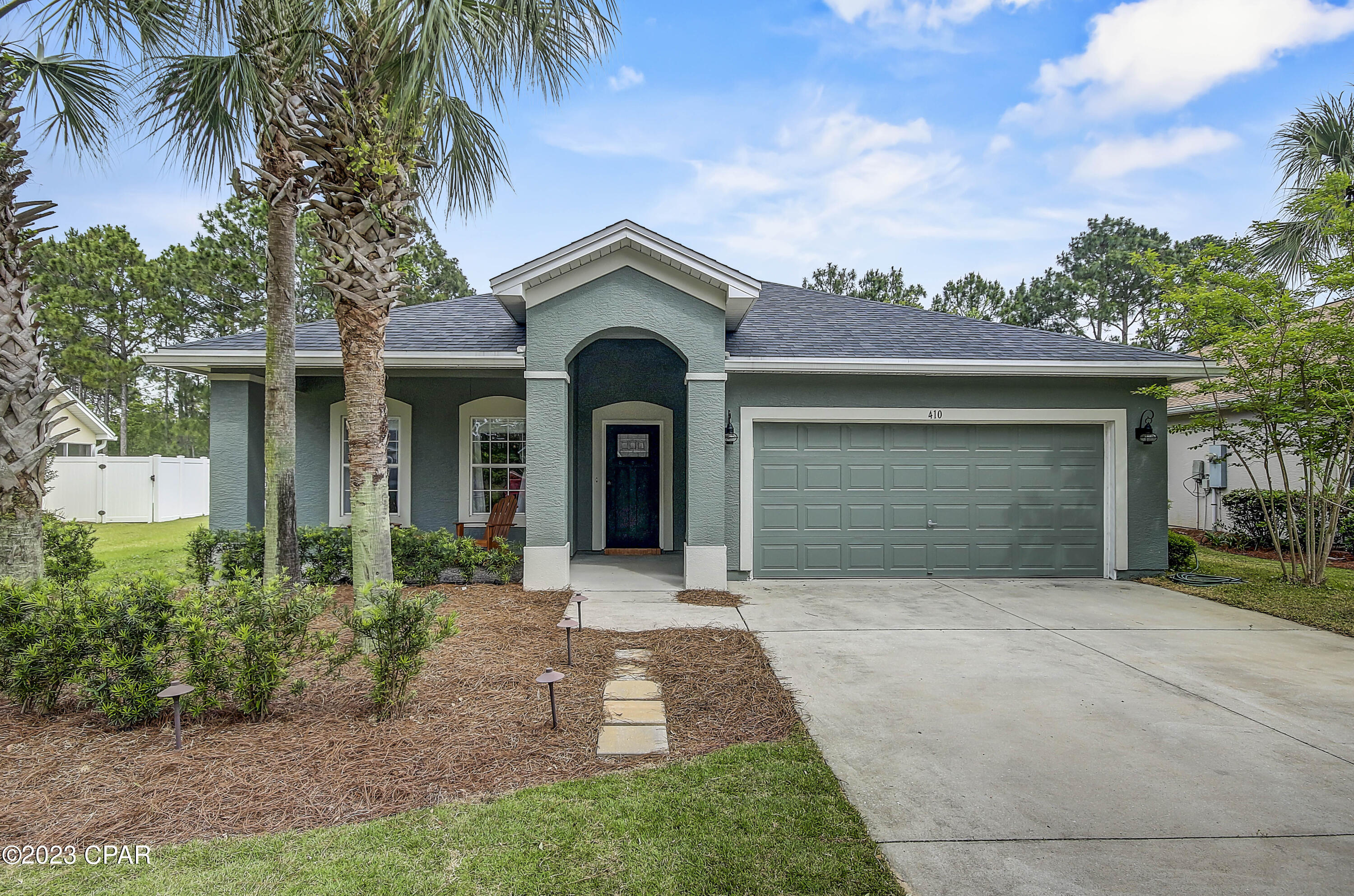 Welcome home!  This 3-bedroom 2 bath home is located in the highly sought after community of Palmetto Trace with beautiful oak-lined streets and centrally located in the heart of Panama City Beach. The beautifully landscaped yard has just been re-sodded and the back yard is a perfect peaceful oasis where you can enjoy watching the deer and eagles from your beautiful fenced in yard overlooking a lovely pond and green space area. From the charming covered front porch, step inside to the formal entry featuring wainscoting and decorative ceiling tiles.  Just off the formal entry, you will find the dining room, which features great natural light, a tray ceiling and updated farmhouse chandelier.  The spacious open concept kitchen and living room are the perfect place for entertaining and family gatherings. It's easy to enjoy cooking with spacious granite countertop space, black stainless-steel appliances (some with Wi-Fi capabilities), a large breakfast bar that will accommodate everyone in the family and a nice size pantry. New, maple soft-close cabinets and beautiful tile backsplash perfectly complement the kitchen décor. The primary bedroom features windows overlooking the beautiful back yard, as well as an enormous walk-in closet and en-suite bathroom with double vanities, soaking tub, and large separate glass shower. Two additional spacious bedrooms and a full bathroom with a tub and shower combination are located down a small hallway along with a linen closet. The ample sized laundry room also serves as a mud room and leads to the oversized 2 car garage that boasts a Rust-Oleum Rocksolid Polycuramine floor, custom garage sink and pull down stairs that lead to an additional storage area above the garage. 
A screened back porch with newly installed ceiling fan also adds additional living and entertaining space and opens to the fully fenced custom landscaped yard with a reclaimed water irrigation system. There are gutters around the entire house.  There is no carpet  all beautiful hard surface floors throughout!  Additionally, custom trim and molding are throughout the entire home.  Bathrooms and kitchen have been remodeled, many light fixtures have been recently updated and walls recently painted making this home ready for you to move into and enjoy right from day one!   

The Palmetto Trace community, includes a community pool, and is located just minutes from Pier Park shopping mall, numerous fantastic restaurants, the Aaron Bessant Park venue, and the Frank Brown Park sports complex. 
Call today for your private showing, this spectacular home will not last long!

All sizes approximate and taken from public records - Buyer to verify all information deemed important.