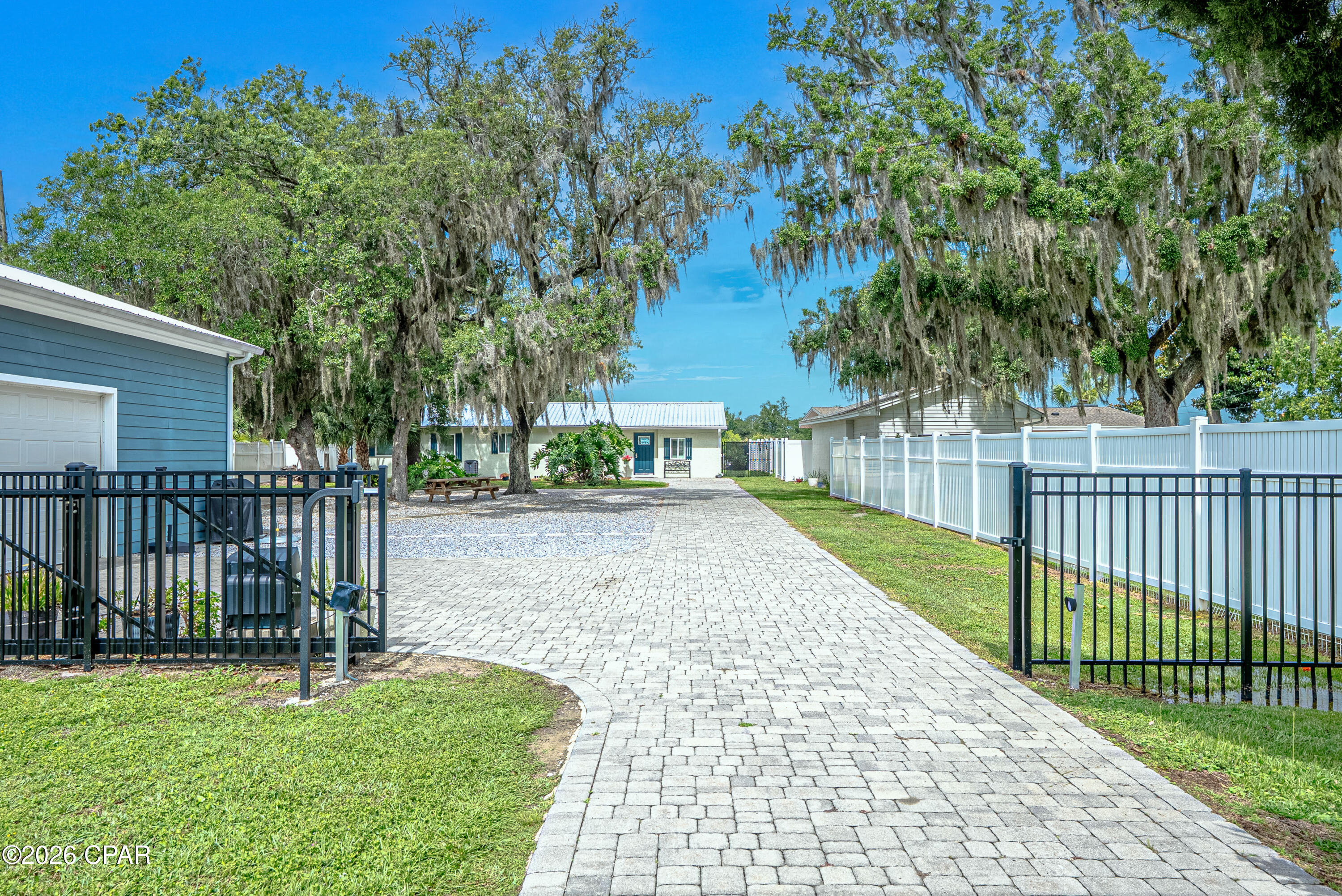 A Waterfront home that is close to everything is here in this beautifully updated 3-bedroom, 2-bath home with additional office/flex areas.  Stunning waterfront views and a home which offers the perfect blend of the boating lifestyle and turnkey coastal living. Situated on a deep 75' x 188' waterfront lot, the property features a professionally installed seawall, twin covered private docks with dual boat lifts capable of accommodating up to a 32' boat and a 25' boat (or 2 jet skis) -- a rare setup for serious boaters seeking protected water access with quick access to the North Bay and Gulf of America.
Inside, the home has been fully updated and designed for comfortable waterfront living. Hurricane-impact windows provide peace of mind and energy efficiency, while the open and inviting interior creates a bright coastal feel throughout. New metal roof 2021, electric and water infrastructure has all been replaced, permitted and updated. 
A standout feature is the impressive 24' x 36' detached two-car garage complete with a conditioned area -- perfect for a workshop or hobby area. 
Step outside to your private backyard retreat featuring a stunning 15' x 38' resort-style pool with massive live oaks. Enjoy the shaded pergola area with expansive waterfront views, and plenty of room to entertain, relax, or enjoy sunset evenings on the water. 
The fully fenced property includes a private electronic gate, creating a secure and secluded waterfront retreat with ample space for vehicles, boats, and outdoor entertainment.  No HOA and is in Bay County zoning. 
Whether you're searching for a primary residence, easy-care second home, income-producing property or premier boating property, this move-in-ready waterfront gem delivers exceptional value with upgrades already complete -- including seawall, covered docks, boat lifts, salt-water pool, interior renovations, newer garage, gated and fenced yard.  Co-owner is a licensed real estate agent. 
Waterfront living at its best.