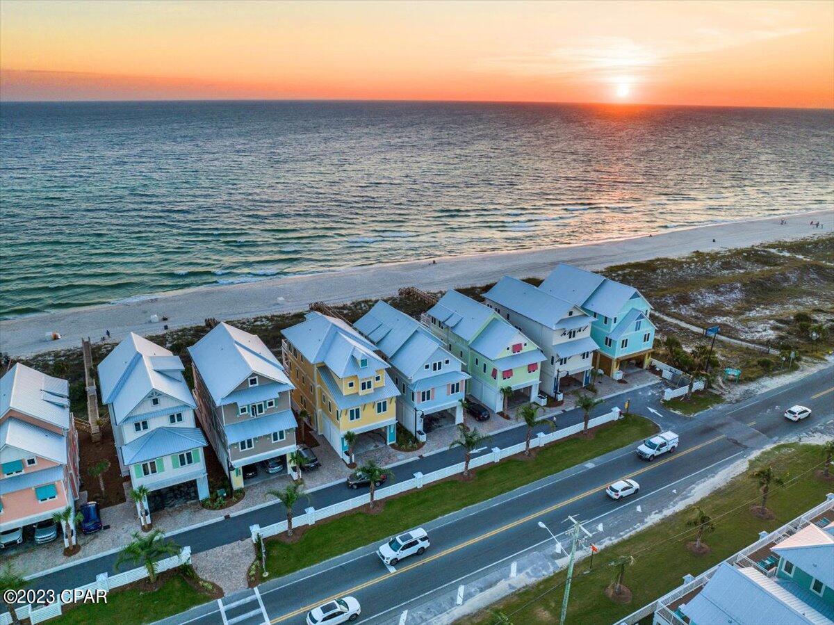 MAJOR PRICE CHANGE, SELLER SAID TO MOVE IT!  This unit was the very first unit on Margaritaville Cottages Rental Program in 2024.  Enjoy your time at PCB's Margaritaville Resort in one of the Best Gulf Front Luxury Beach House in the Resort. Beach Villa 2 has the Best Gulf Views and as well easy access from Front Beach Road.  The Oasis Floor Plan features over 3784 SF of living space with an endless view from the balconies on each floor with Two Master suites on the Third Floor.  The First Floor offers a Recreation Room with Mini-Kitchen, and a with a gaming area with Pool Table, Bunk Room and an Elevator as well as entry to the oversize deck featuring a Private Pool, oversize deck with Grill & a Private Beach walkover with outside shower.  The second floor features the living area with an open Great Room that opens to an oversize balcony with endless views East and West, Two Bedrooms with Ensuite Baths and a large laundry with additional storage.  The Third Floor offers three bedrooms, all with ensuite baths, with two being master bedrooms on the Gulf side with endless views of the coastline of PCB. All this with the amenities of Margaritaville PCB Resort including The Salty Rim Bar & Grill, Fins Restaurant and Bar and a 425-foot lazy rive Lagoon Pool that is Margaritaville's signature at each of their Resorts.  Get ready for good times as it's 5 o'clock somewhere at Margaritaville Resort. Established Rental history and booked solid for 2025.  History and current booking are available.