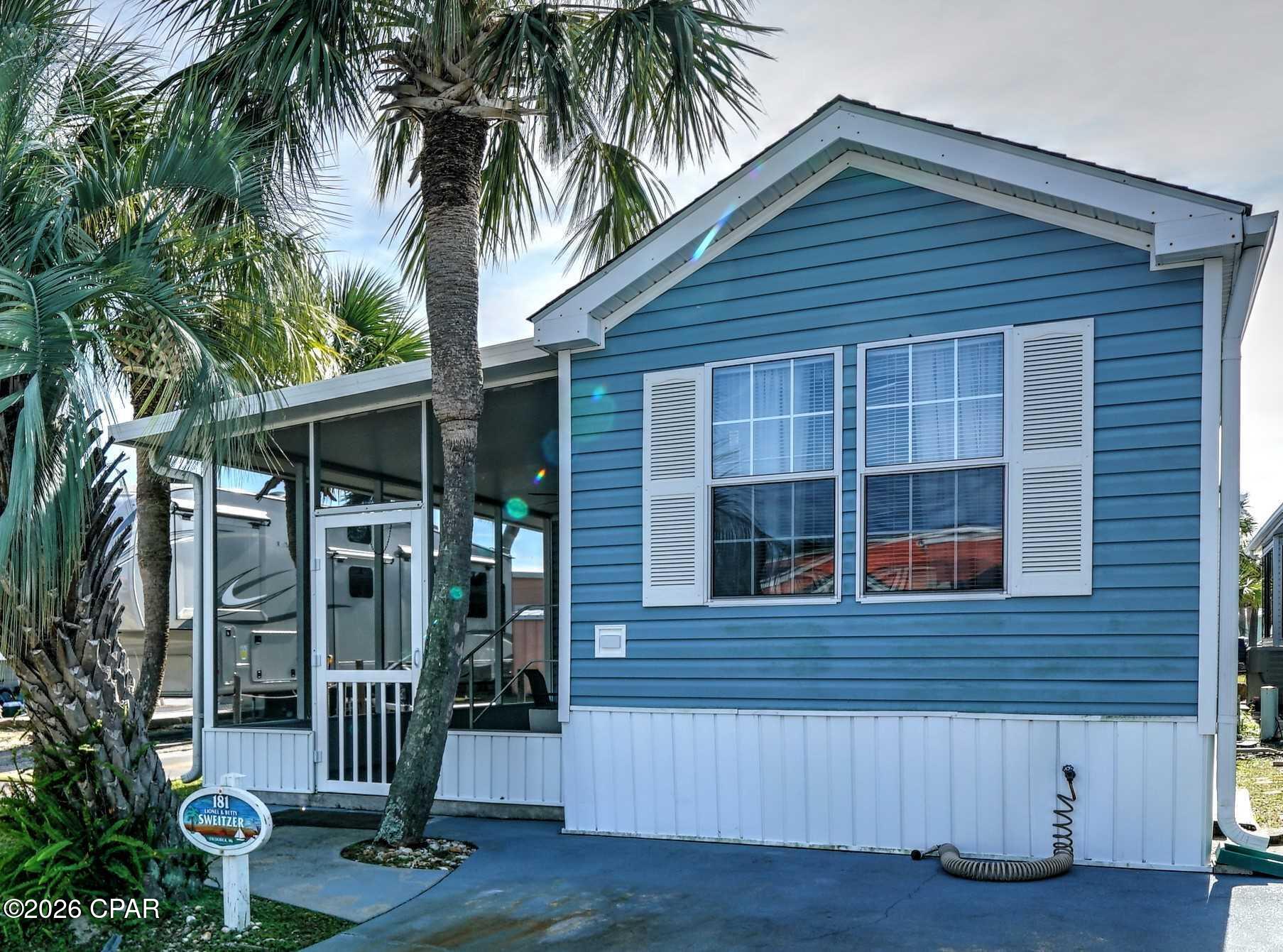 Charming 1-bedroom, 1-bath beach retreat located in the highly sought-after Venture Out gated community! This well-maintained home offers the perfect combination of comfort, privacy, and convenience. Situated adjacent to a golf cart path, you'll enjoy additional open space between neighboring properties, creating a more spacious feel and enhanced privacy rarely found in the community.

Inside, you'll find an inviting open-concept living area with vaulted ceilings, abundant natural light, and an efficient kitchen with ample cabinet space. Relax in the large screened porch, the perfect spot for morning coffee or unwinding after a day at the beach.

The oversized concrete driveway provides plenty of parking for vehicles and a golf cart. The low-maintenance exterior and attractive landscaping make this an ideal primary residence, vacation home, or income-producing rental property.

Located in the gated waterfront community of Venture Out, owners and guests enjoy approximately 300 feet of private Gulf of Mexico beach frontage and over 1,000 feet of Grand Lagoon frontage, along with two swimming pools, a fishing pier, boat ramp, marina, tennis courts, pickleball, shuffleboard, basketball court, playground, and 24-hour gated security.

Whether you're looking for an affordable beach getaway or an investment opportunity, this home offers an exceptional location with added privacy and all the amenities that make Venture Out one of Panama City Beach's most desirable communities. Don't miss this opportunity to own your piece of paradise!