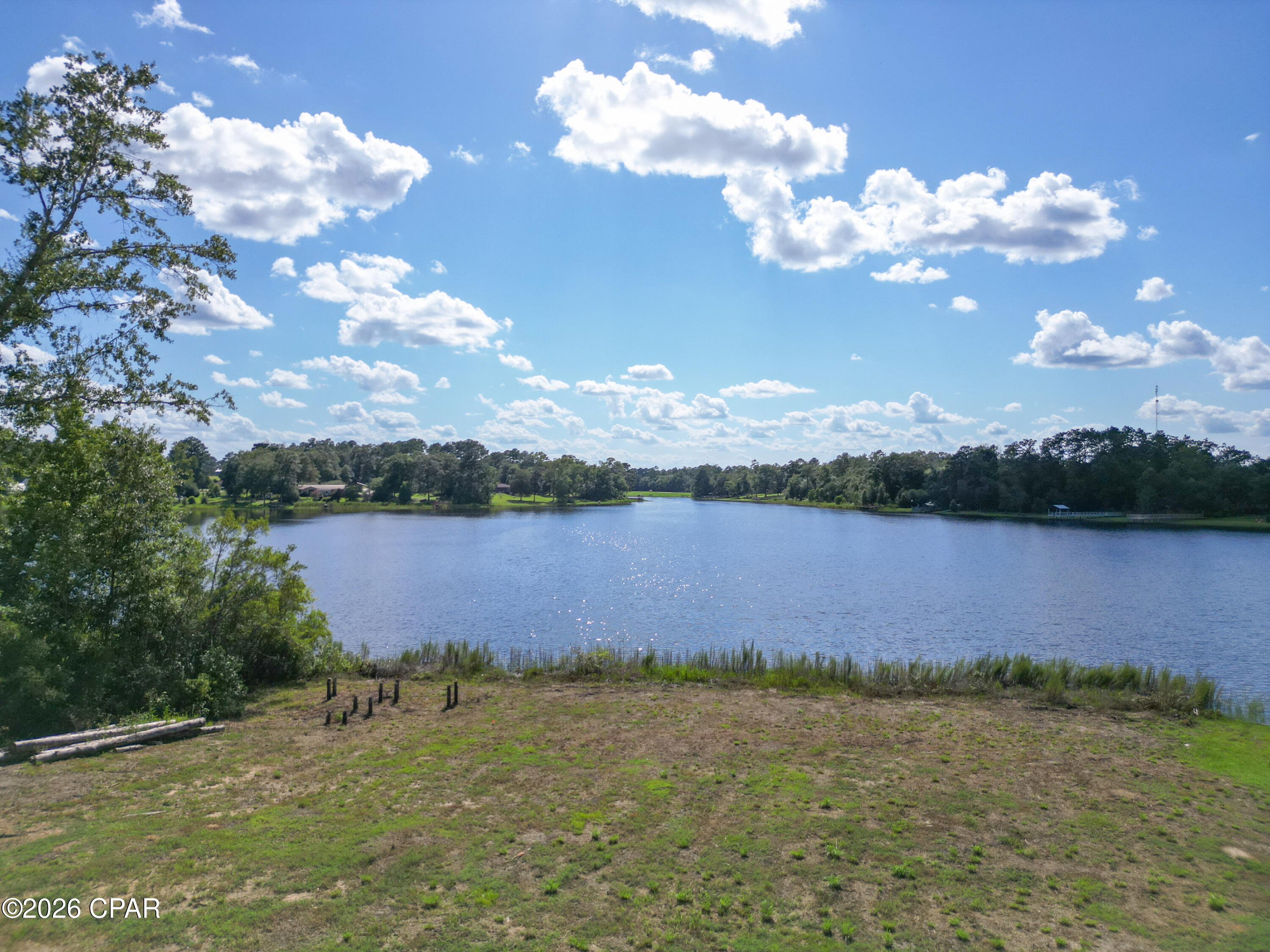 Desirable waterfront lot located on the larger lake in the Dogwood Lakes Community! This flat, cleared homesite is ready for your dream home and offers beautiful lake views and stunning sunsets. Situated directly across from the 18-hole golf course, the property provides convenient access to fishing, boating, and recreation. The community features two lakes, with a public boat ramp located on the larger lake. Don't miss this opportunity to own a premier lot in a sought-after lake community!