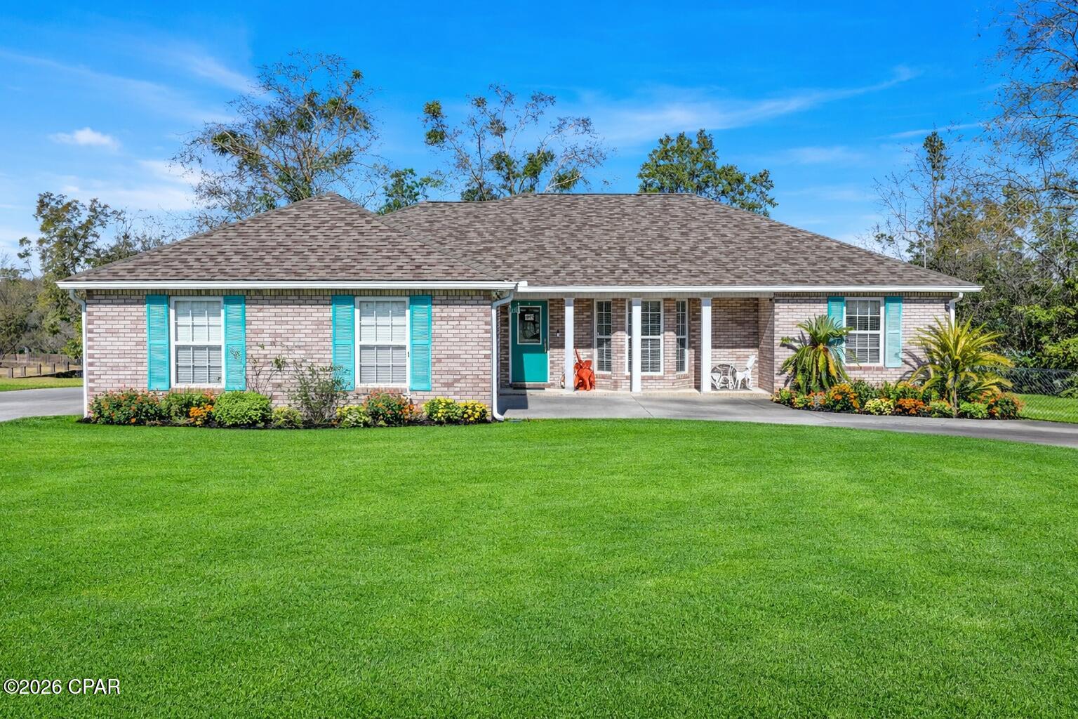 Tucked away on .59 acres, this custom-built 3-bedroom, 2-bath home offers the perfect blend of peaceful, rural living and everyday convenience. With no HOA and a fully fenced backyard, this property is ideal for anyone craving space, privacy, and freedom, whether that means room for animals, a garden, or simply enjoying quiet evenings at home.

Inside, you'll find 1,673 sq. ft. of thoughtfully designed living space, highlighted by a vaulted living room that feels open and welcoming. The kitchen and bathrooms feature custom Alder wood cabinetry, and tile flooring throughout adds both durability and easy maintenance.

The spacious primary suite serves as a private retreat with double vanities, a Jacuzzi tub, and a large walk-in closet, while the split floor plan places the additional bedrooms and full bath on the opposite side of the home, perfect for privacy.

Out back, enjoy a screened-in porch with space for a TV, an ideal setup for watching football games or relaxing in the evenings, plus a large wood deck perfect for entertaining or enjoying the peaceful surroundings. The circular driveway provides easy access and plenty of parking. Located just off Highway 231, this home feels secluded yet remains convenient, only 15 minute drive from Panama City's major shopping centers and 8 minute drive from Publix.

If you're looking for quiet country living without sacrificing access to town, this home delivers the best of both worlds. Schedule your private showing today and experience the space and serenity for yourself.