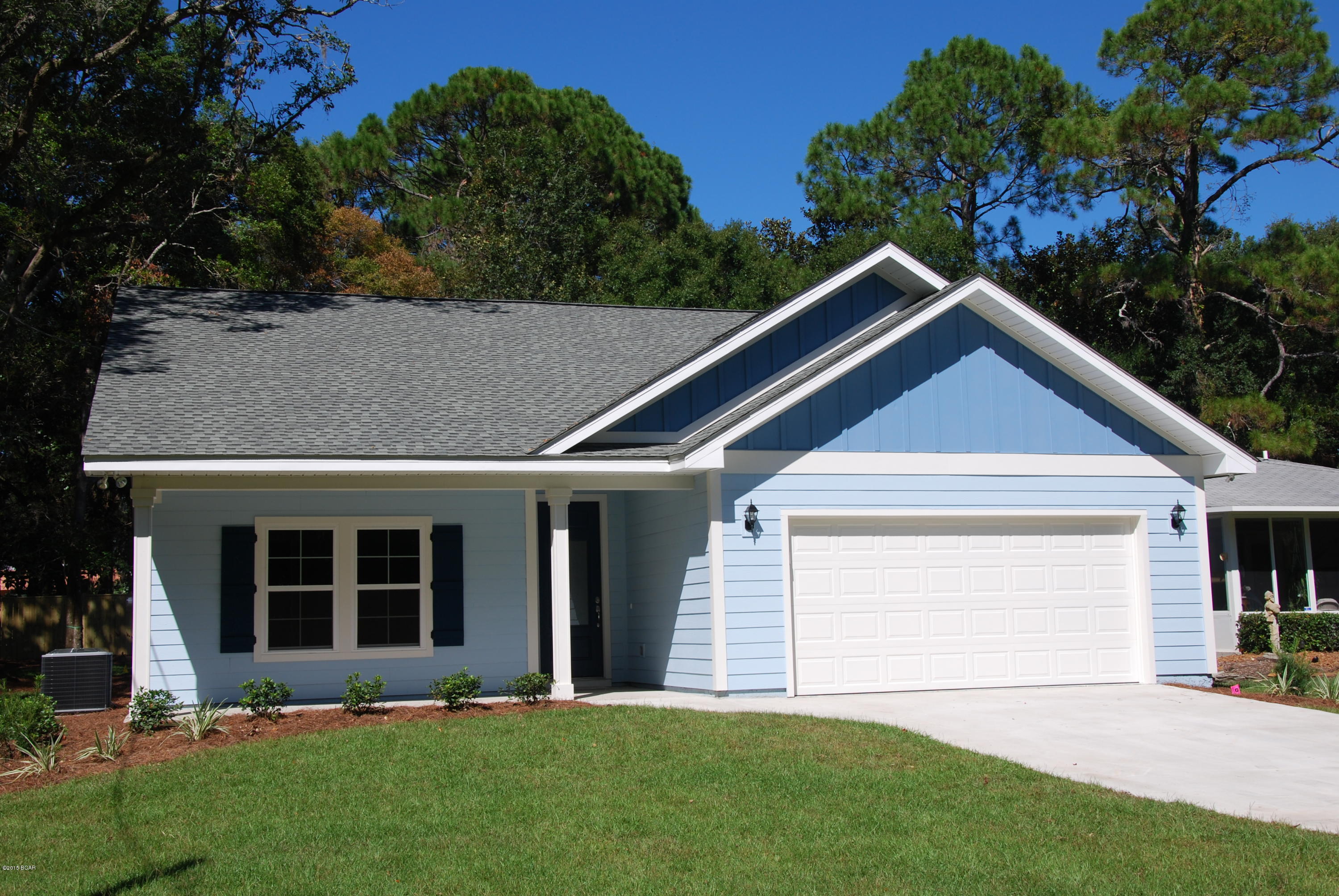 TAKE ADVANTAGE OF A UNIQUE OPPORTUNITY TO PURCHASE A BRAND NEW HOME IN HISTORIC ST. ANDREWS.  Steps away from the bay and a short driving distance to Panama City Beach, you will be welcomed by this attractively designed home nestling in the shade provided by a number of giant age old trees.  Professional landscaping further enhances the appeal.  As soon as you walk through the eight foot high front door you immediately recognize the many outstanding features of the free flowing floor plan, which cannot be found in most other homes in the St. Andrews area:  ten foot high ceilings, two-panel “Cheyennne” style interior doors, and pseudo wood floors throughout the living areas of the home. An open plan kitchen with granite countertops, stainless steel appliances  and an eye-catching tiled backsplash are sure to impress the cooking enthusiast.  The master bedroom features a double marble top vanity, a tiled shower, as well as an oversized walk-in closet.  Faucets and door hardware throughout the home have a brushed nickel finish.  The sliding glass rear door opens onto a spacious covered porch and secluded rear garden, perfect for those barbecue evenings and entertaining.  Privacy is assured by a six foot high closed- boarded fence erected around the large rear yard of the property.  Construction of the home incorporates hardi-board siding, low maintenence vinyl soffits, and a termite treated foundation.  There is a spacious two car garage.  Other outstanding features of this home include a walk-in laundry room, security system, and a 2-10 Home Buyers Warranty.  All dimensions are approximate and should be measured for accuracy.