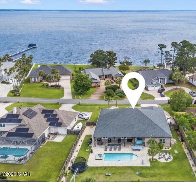 Welcome to your dream home in the highly sought-after Colony Club -- where luxury, space, and the ultimate Florida lifestyle come together. Situated on an oversized homesite across from the bay with peekaboo water views, this stunning one story 4-bedroom, 3-bath residence offers an incredible blend of comfort, function, and resort-style outdoor living.

Step inside to discover an expansive open-concept floor plan featuring a massive living area, oversized dining space, and an enormous chef's kitchen designed for gathering and entertaining. Two additional flex spaces provide endless possibilities for home offices, playrooms, fitness rooms, or guest overflow.

The grand primary suite is a true retreat, complete with a spacious bedroom, spa-inspired bathroom featuring a soaking tub, oversized shower, separate vanities, and generous custom closet systems. Every closet throughout the home includes custom built-in shelving for elevated organization and style.

Outside is where this property truly becomes unforgettable. The backyard is nothing short of extraordinary -- one of the largest and most impressive entertaining spaces you'll find. Designed for hosting and making memories, it features a beautiful pool,  fire pits and chimineas, outdoor TV lounge, grilling area, and endless green space with room for soccer games, a volleyball court, and more. This is the kind of backyard people dream about.

Located in the heart of the Legacy Golf Club golf course community, you're just minutes from Pier Park, 30A, Frank Brown Park, top-rated schools, shopping, dining, Topgolf, and the new hospital. Enjoy quick access to Highway 79 for easy travel and less time in traffic -- plus take your golf cart to the beach anytime you want.

Spacious, beautifully designed, and built for entertaining, this home offers the best of coastal living with room to truly live, relax, and play.

*All measurements are approximate. Confirm if important*