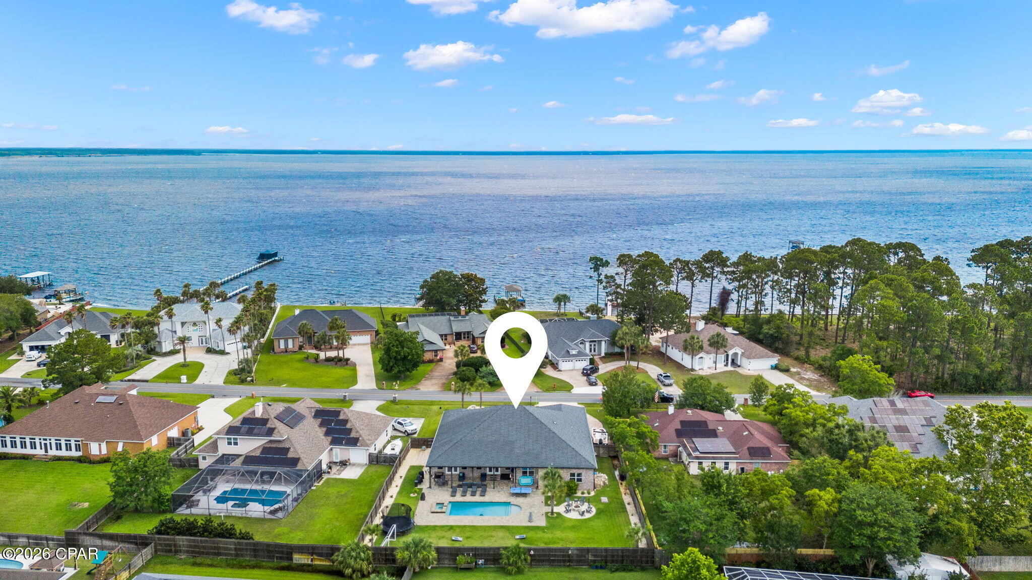 Welcome to your dream home in the highly sought-after Colony Club NO HOA  and where luxury, space, and the ultimate Florida lifestyle come together. Situated on an oversized homesite across from the bay with peekaboo water views, this stunning one story 4-bedroom, 3-bath residence offers an incredible blend of comfort, function, and resort-style outdoor living.

Step inside to discover an expansive open-concept floor plan featuring a massive living area, oversized dining space, and an enormous chef's kitchen designed for gathering and entertaining. Two additional flex spaces provide endless possibilities for home offices, playrooms, fitness rooms, or guest overflow.

The grand primary suite is a true retreat, complete with a spacious bedroom, spa-inspired bathroom featuring a soaking tub, oversized shower, separate vanities, and generous custom closet systems. Every closet throughout the home includes custom built-in shelving for elevated organization and style.

Outside is where this property truly becomes unforgettable. The backyard is nothing short of extraordinary -- one of the largest and most impressive entertaining spaces you'll find. Designed for hosting and making memories, it features a beautiful pool,  fire pits and chimineas, outdoor TV lounge, grilling area, and endless green space with room for soccer games, a volleyball court, and more. This is the kind of backyard people dream about.

Located in the heart of the Legacy Golf Club golf course community, you're just minutes from Pier Park, 30A, Frank Brown Park, top-rated schools, shopping, dining, Topgolf, and the new hospital. Enjoy quick access to Highway 79 for easy travel and less time in traffic -- plus take your golf cart to the beach, pier park, Thomas Donuts anytime you want.

Spacious, beautifully designed, and built for entertaining, this home offers the best of coastal living with room to truly live, relax, and play.

*All measurements are approximate. Confirm if important*